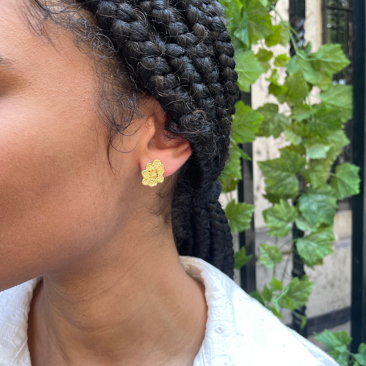 Small, exquisite stud earring in the shape of a lace flower dipped in 24k gold.