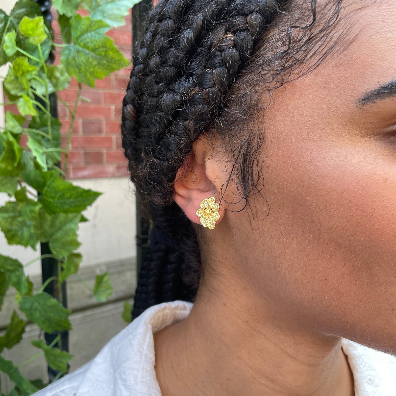 Small, exquisite stud earring in the shape of a lace flower dipped in 24k gold.