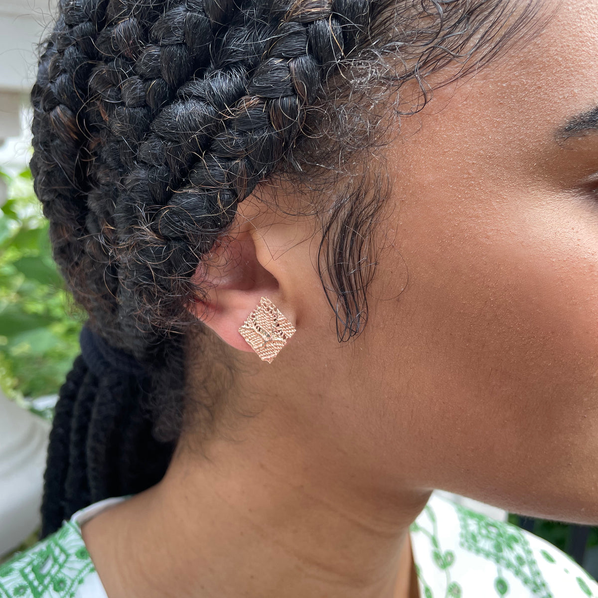 Lace Stud Earrings Diamond Shaped with Chantilly lace inside dipped in rose gold on model.