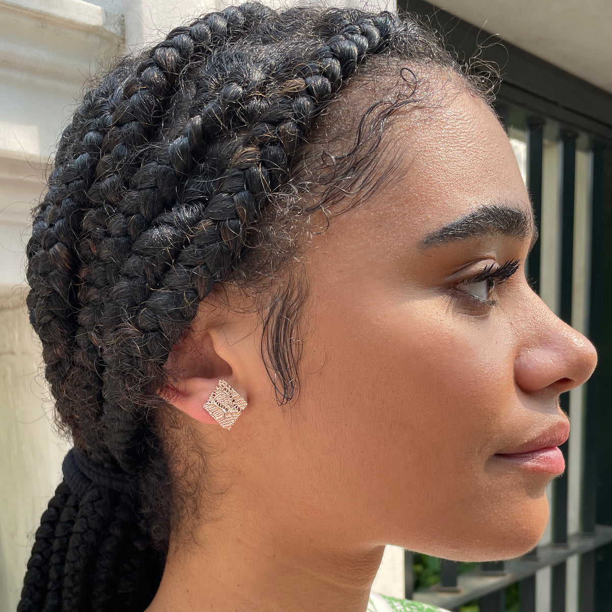 Lace Stud Earrings Diamond Shaped with Chantilly lace inside dipped in rose gold on model.