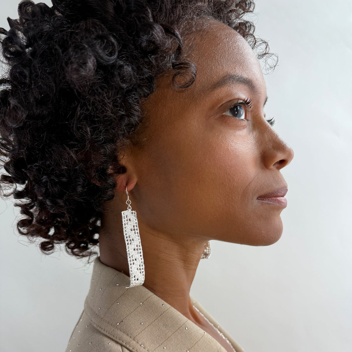 A model wearing Signe, long lace earrings in sterling silver.