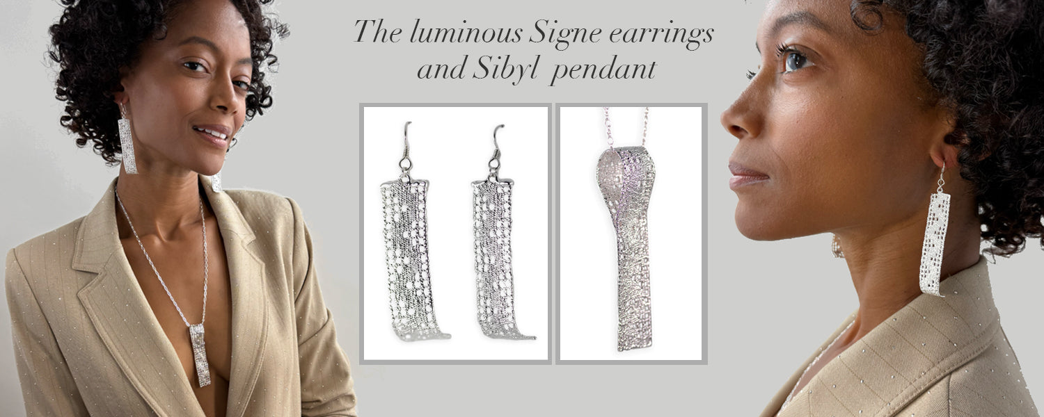 A model wearing long silver lace earrings and a long silver lace pendant.