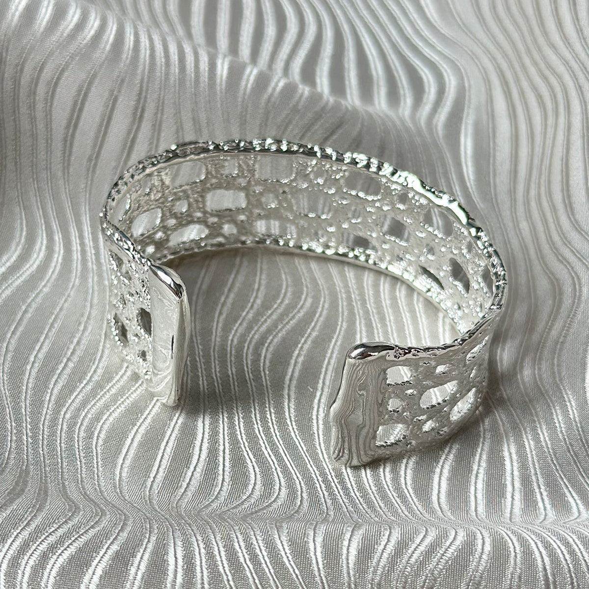 The back of French lace cuff bracelet dipped in sterling silver.