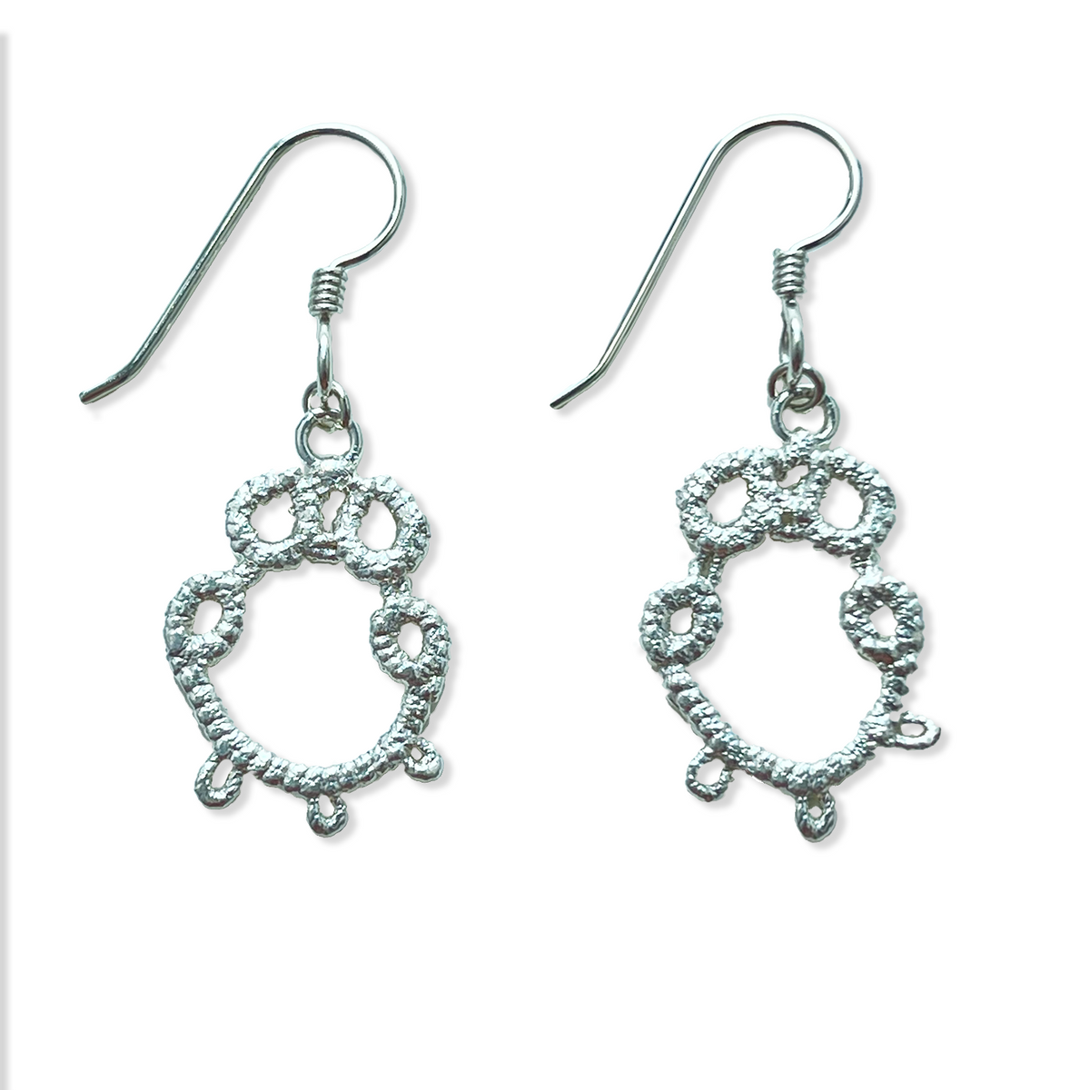 Irish tatted lace earrings in sterling silver on French hooks.