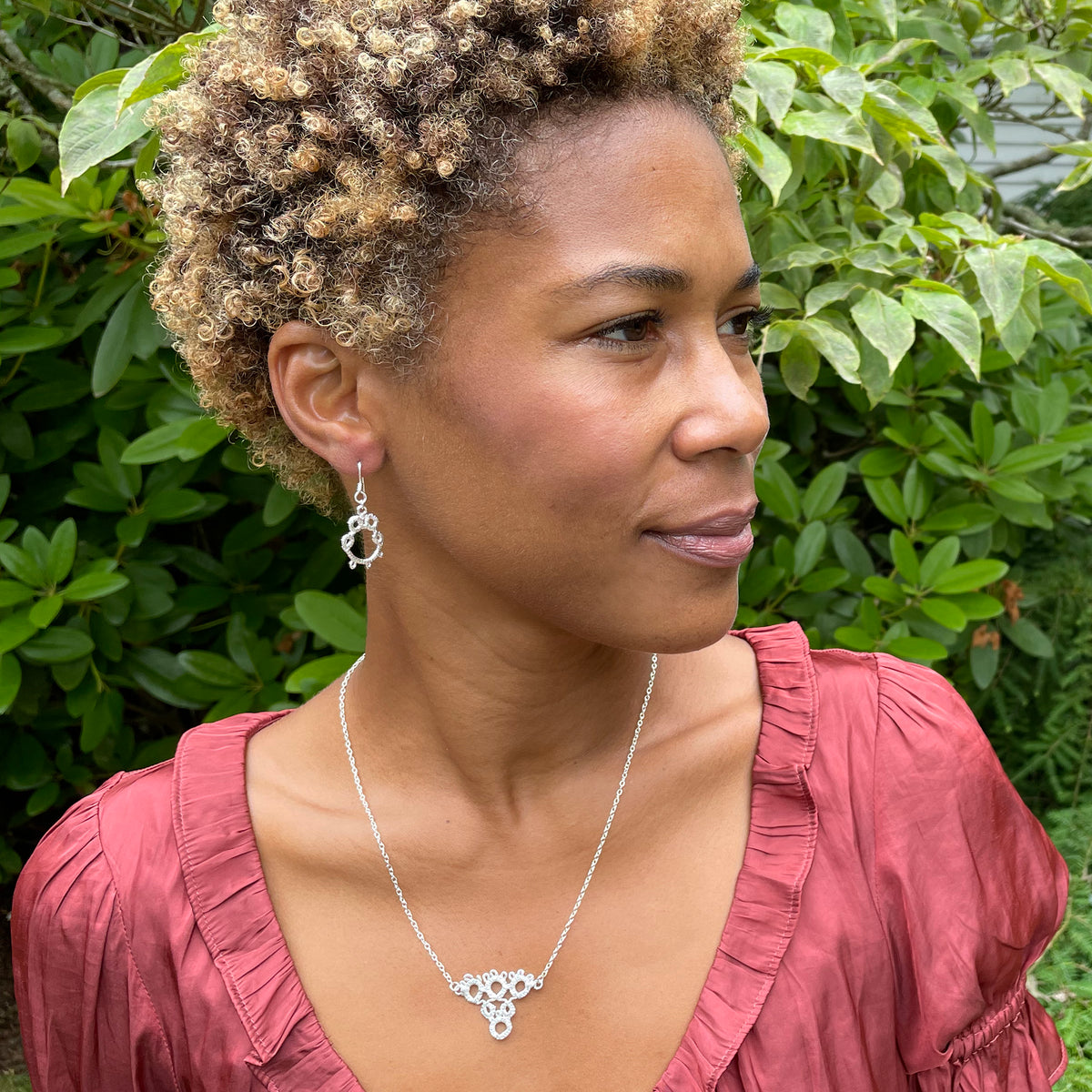 Irish tatted lace pendant necklace in sterling silver on model.