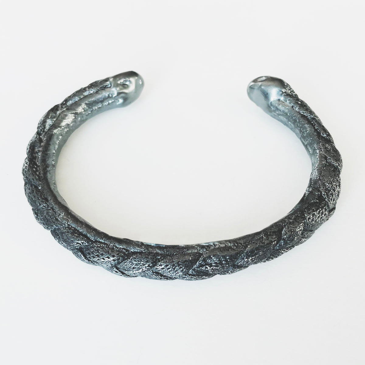 Braided open men&#39;s bangle bracelet in dark oxidized sterling silver.