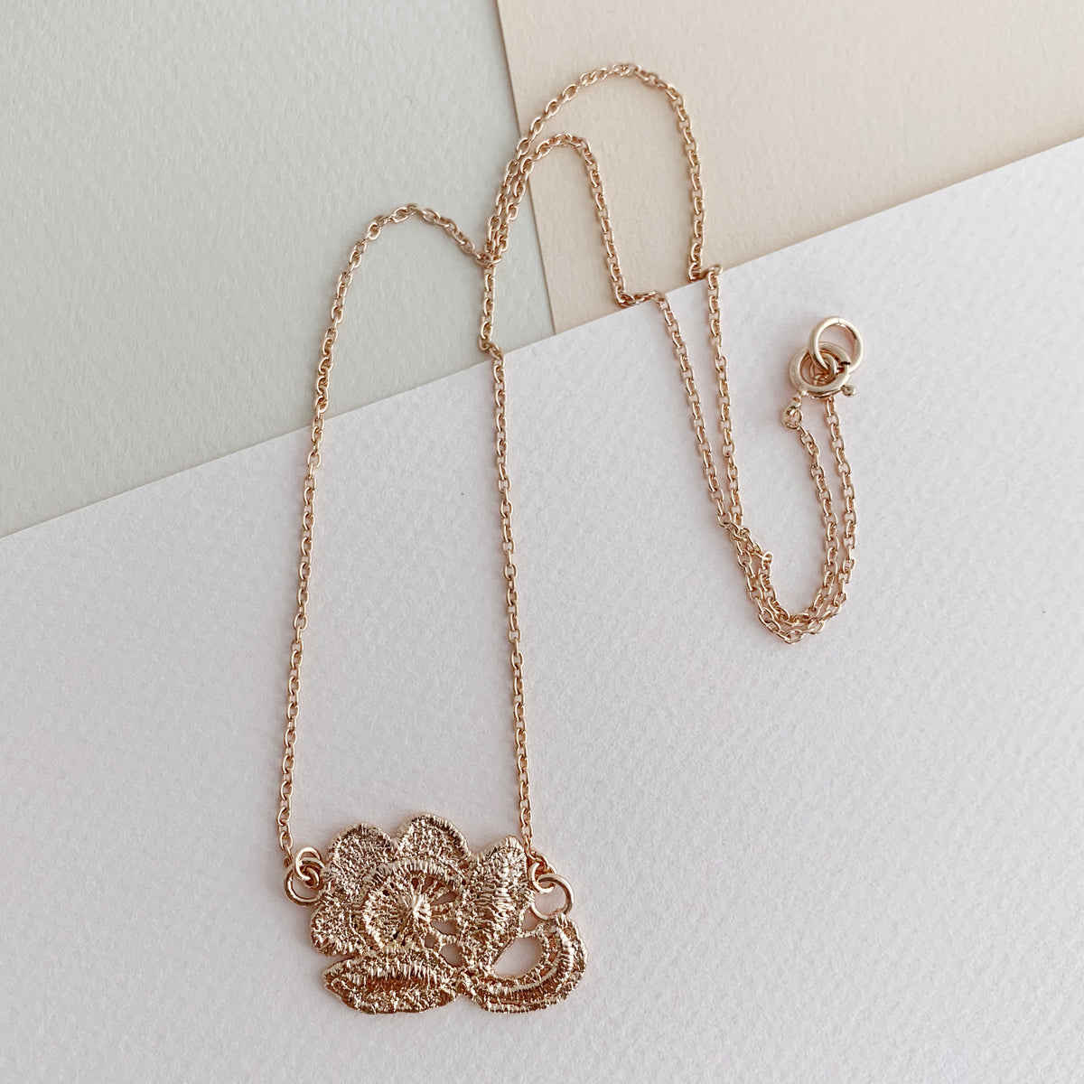 Fine lace rose necklace in rose gold.