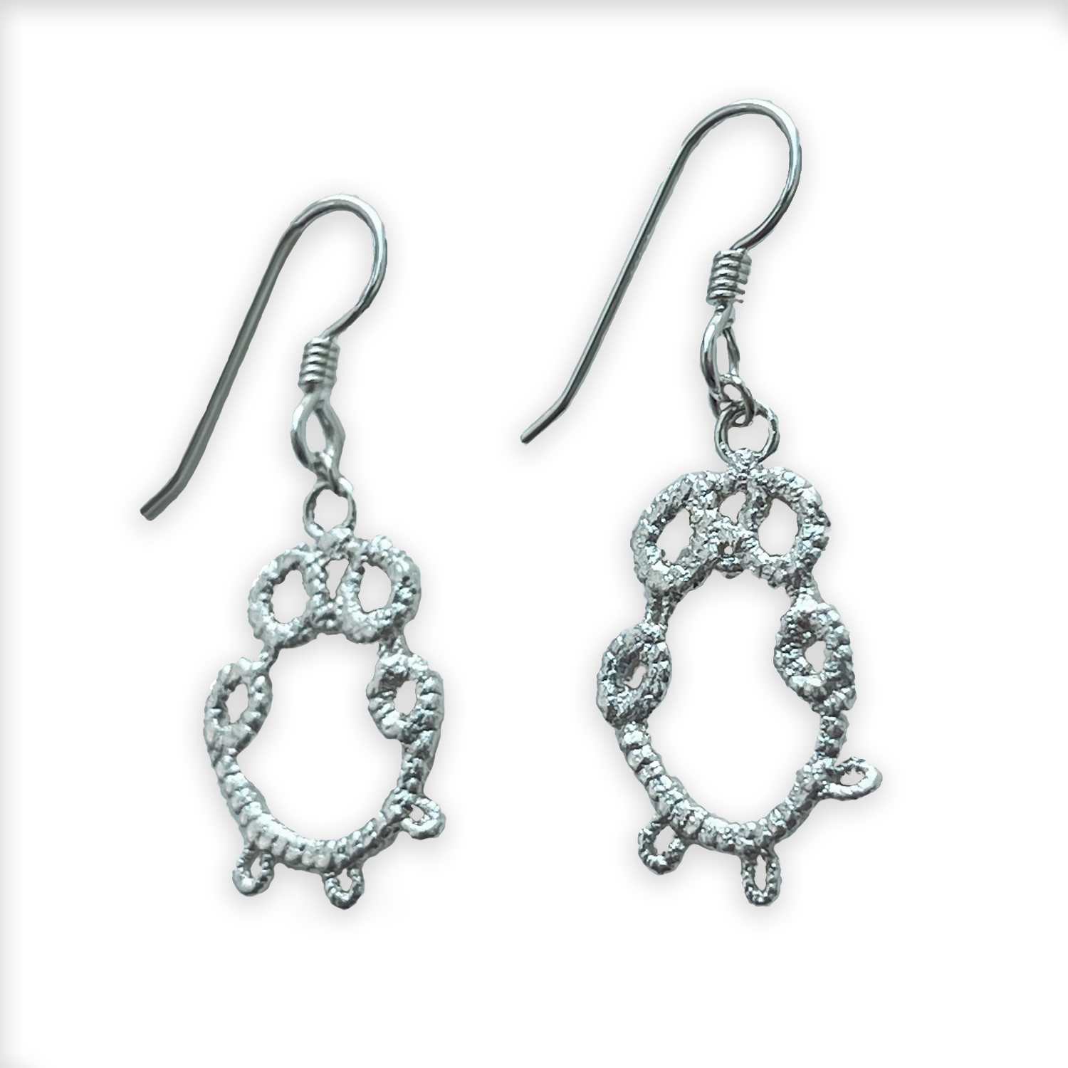 Irish tatted lace earrings in sterling silver on French hooks.