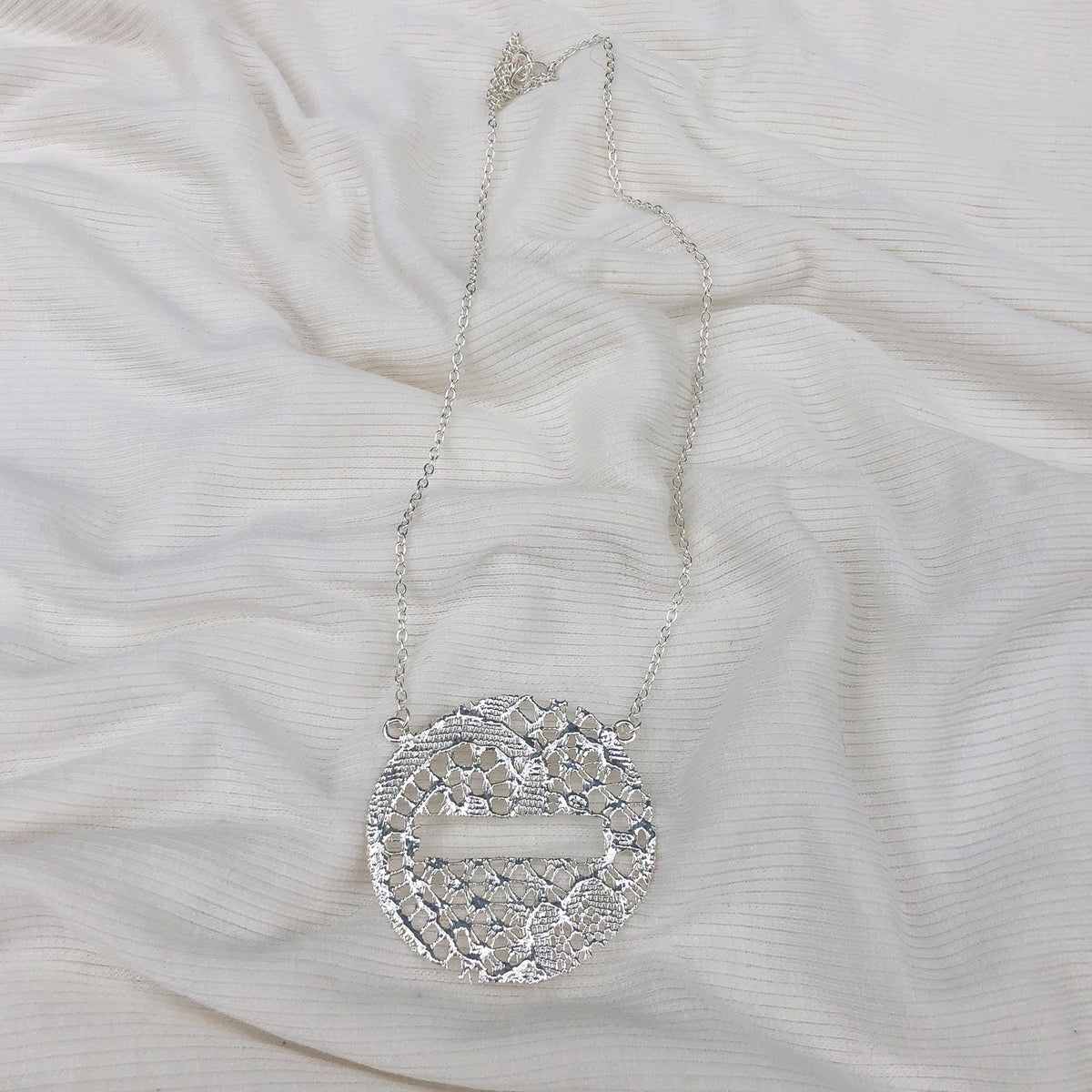 Intricate lace necklace in the shape of a DO NOT ENTER traffic sign in sterling silver.