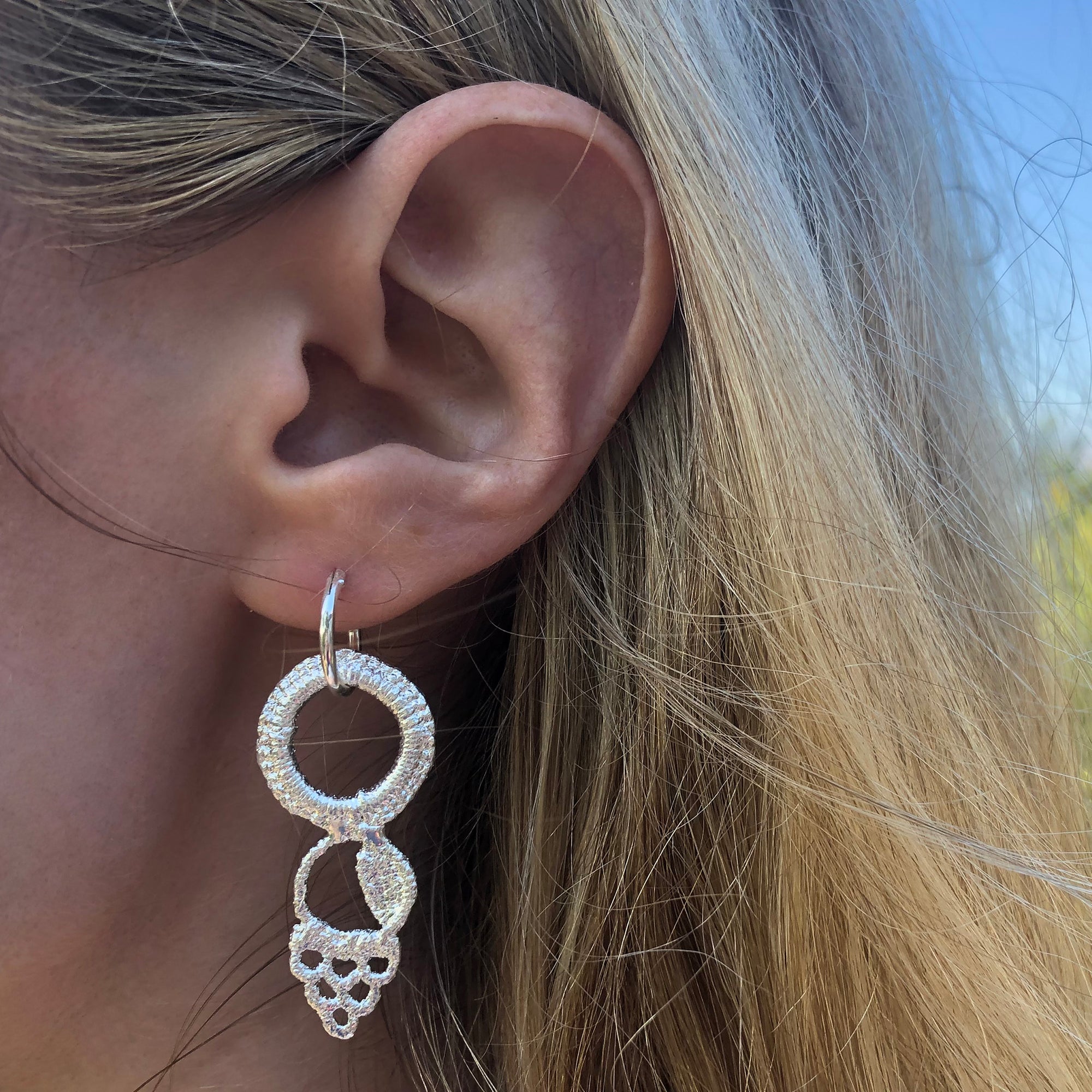 Hoop earrings made from Art Deco lace dipped in sterling silver, handmade in New York.