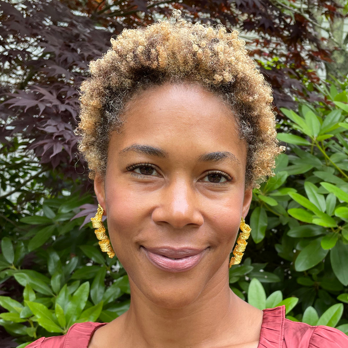 Azeline lace swirl and drop earrings in 24k gold worn by model.