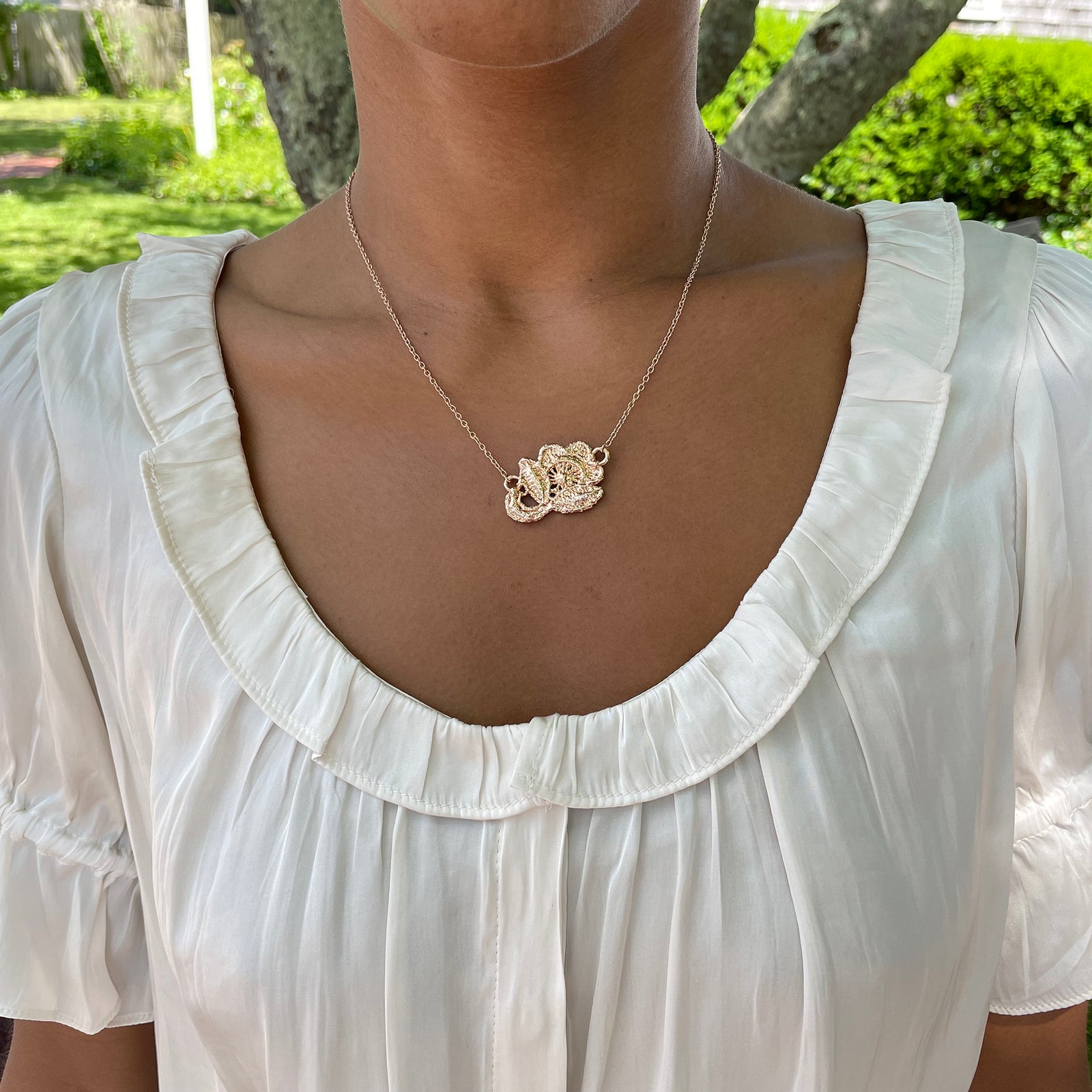 Fine lace rose necklace in 24k gold.
