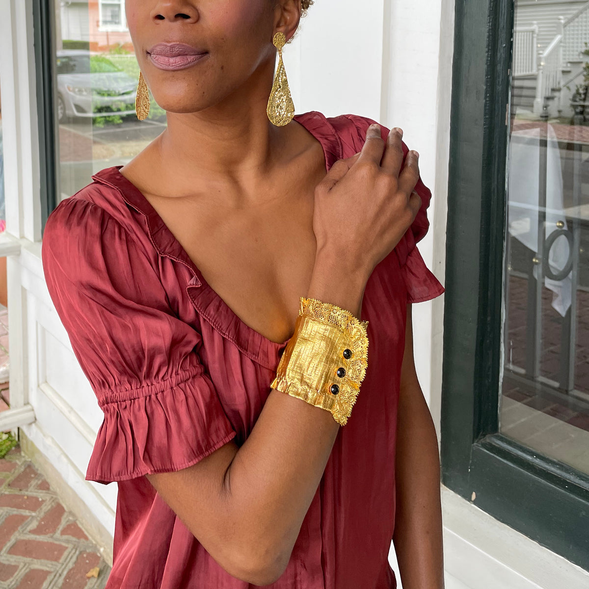 Stunning lace cuff bracelet in 24k gold with three faceted stones.
