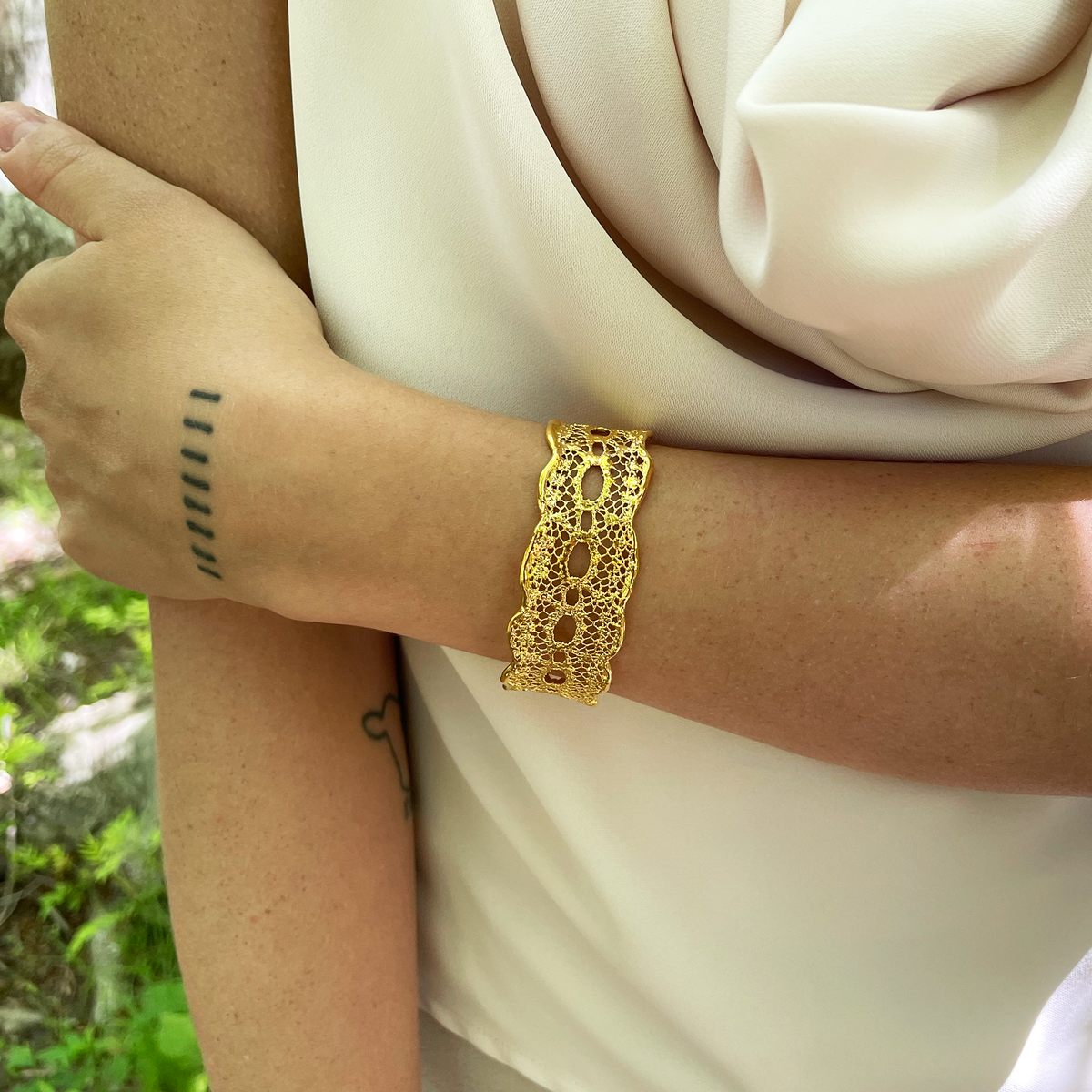 Zelia lace cuff bracelet in 24k gold ressembling a tattoo.