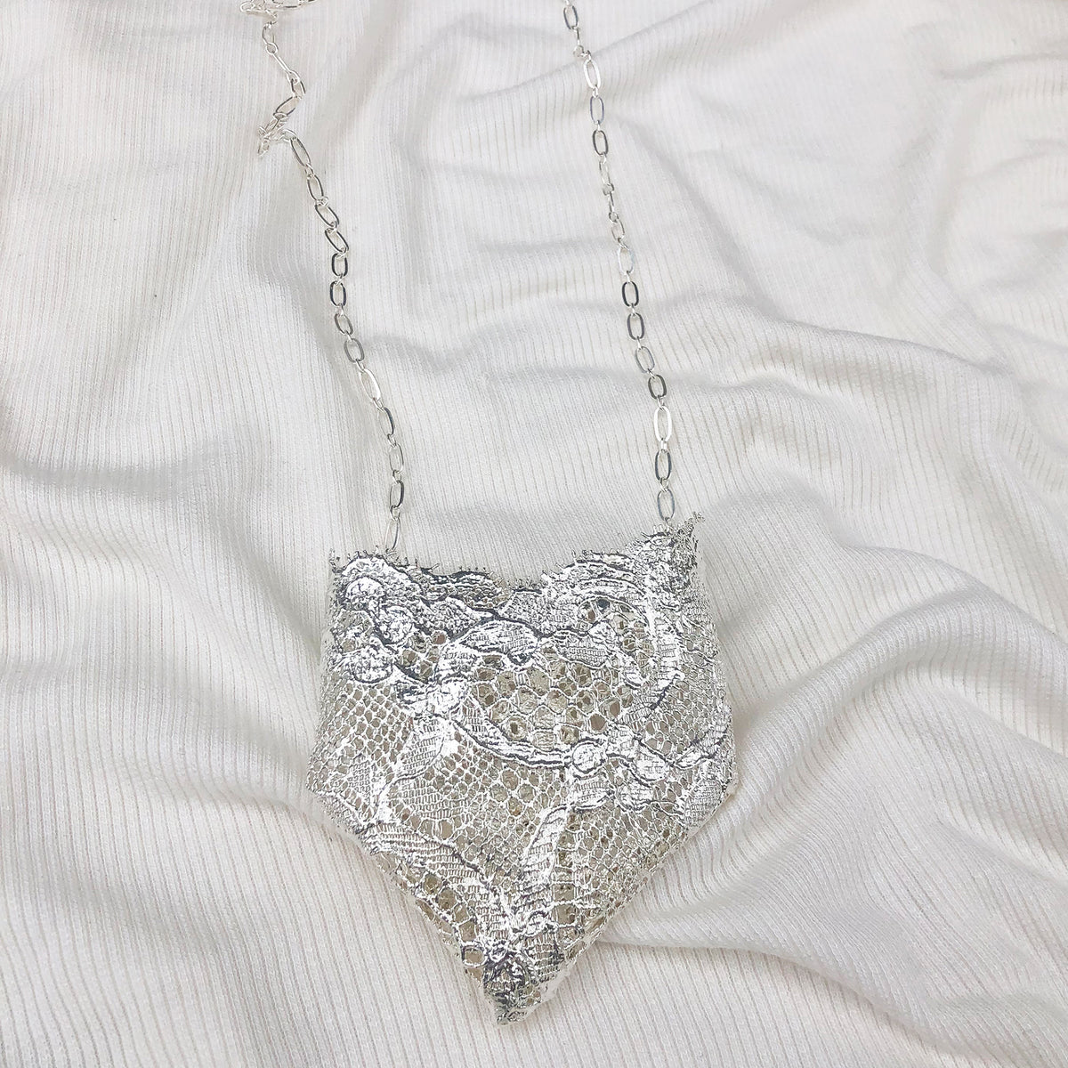 Brooch and Necklace in One. Jewelry dipped in Sterling Silver. Holder for flowers or fragrance sachet.