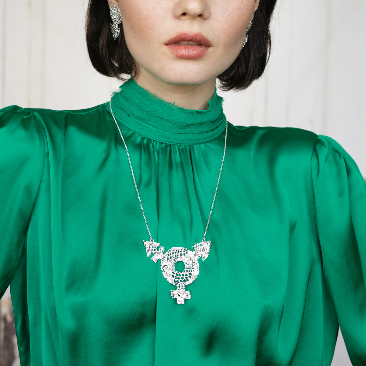 Model Showing Inclusive Lace Necklace with Female, Male and Non-Binary Symbols. Chantilly Lace dipped in Sterling Silver.