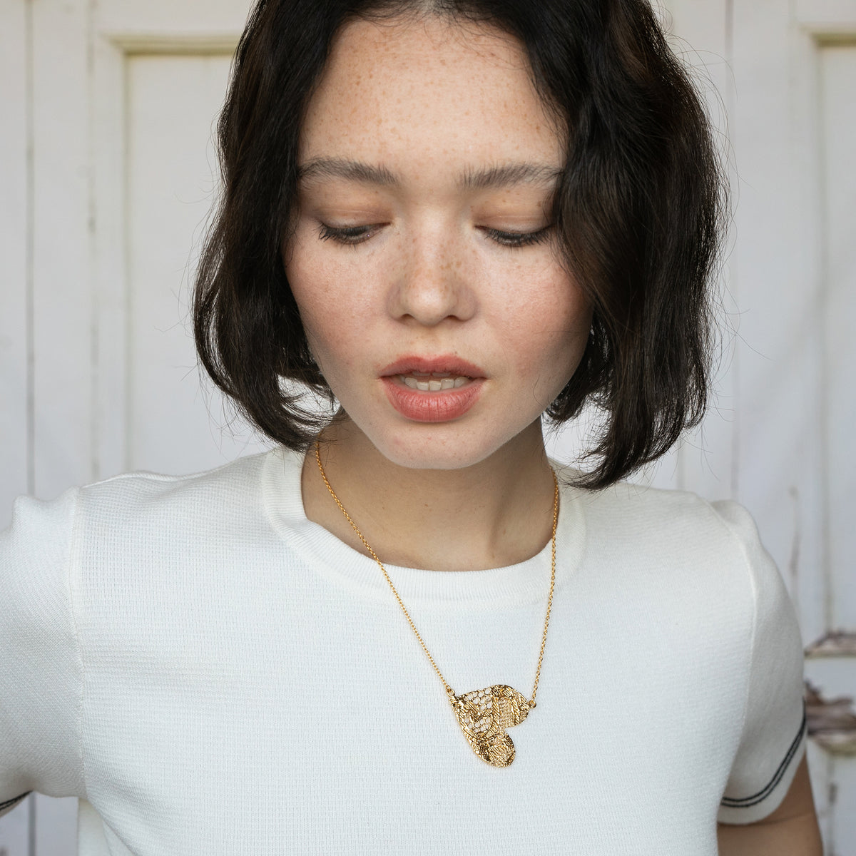 Model with Lace Heart Necklace. Unique 13th anniversary gift. Made from European Chantilly lace dipped in 24k gold.