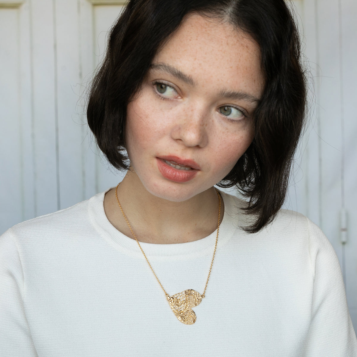 Model with Lace Heart Necklace. Unique 13th anniversary gift. Made from European Chantilly lace dipped in 24k gold.
