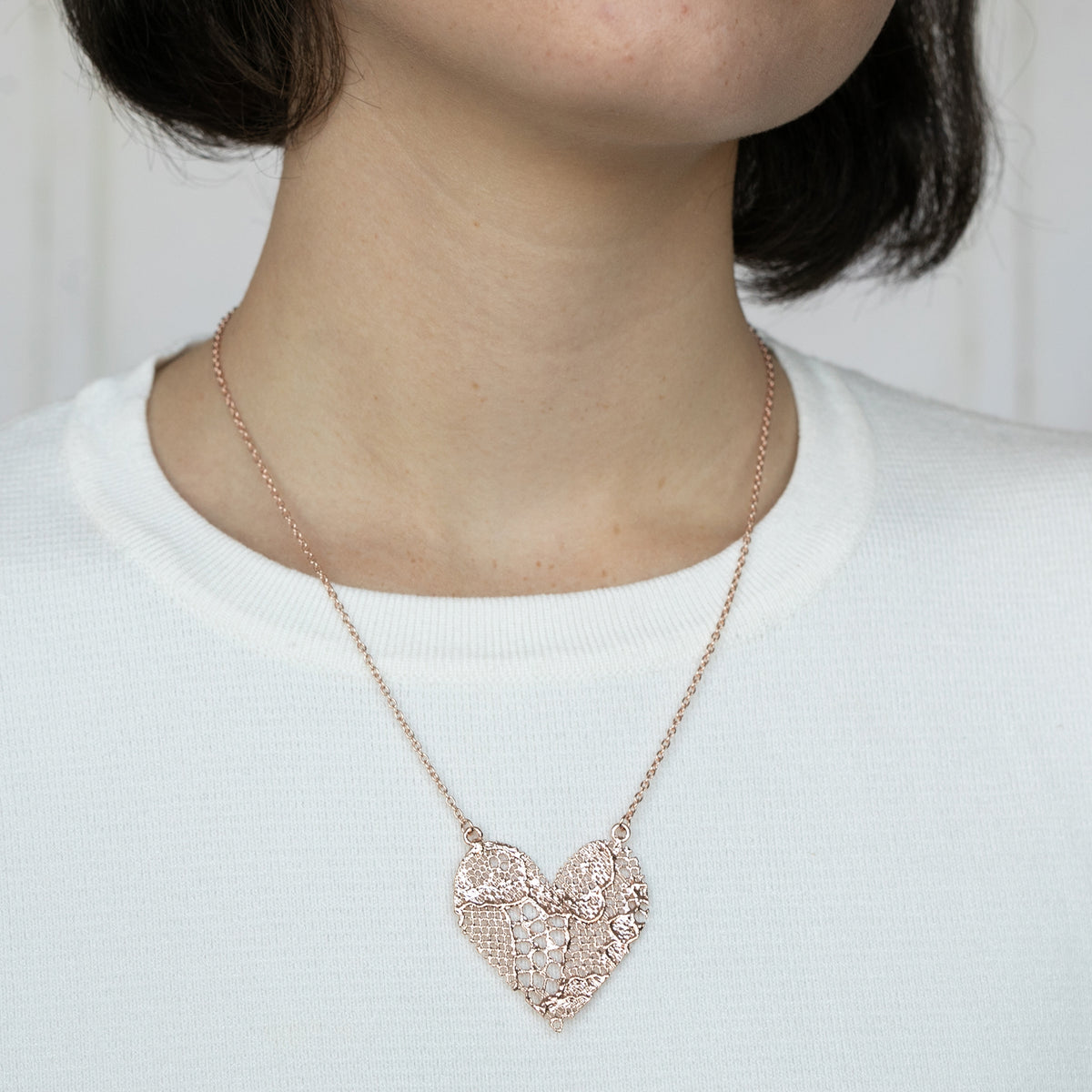 Model with Lace Heart Necklace. 13th anniversary gift with a WOW factor. Made from European Chantilly lace dipped in rose gold.