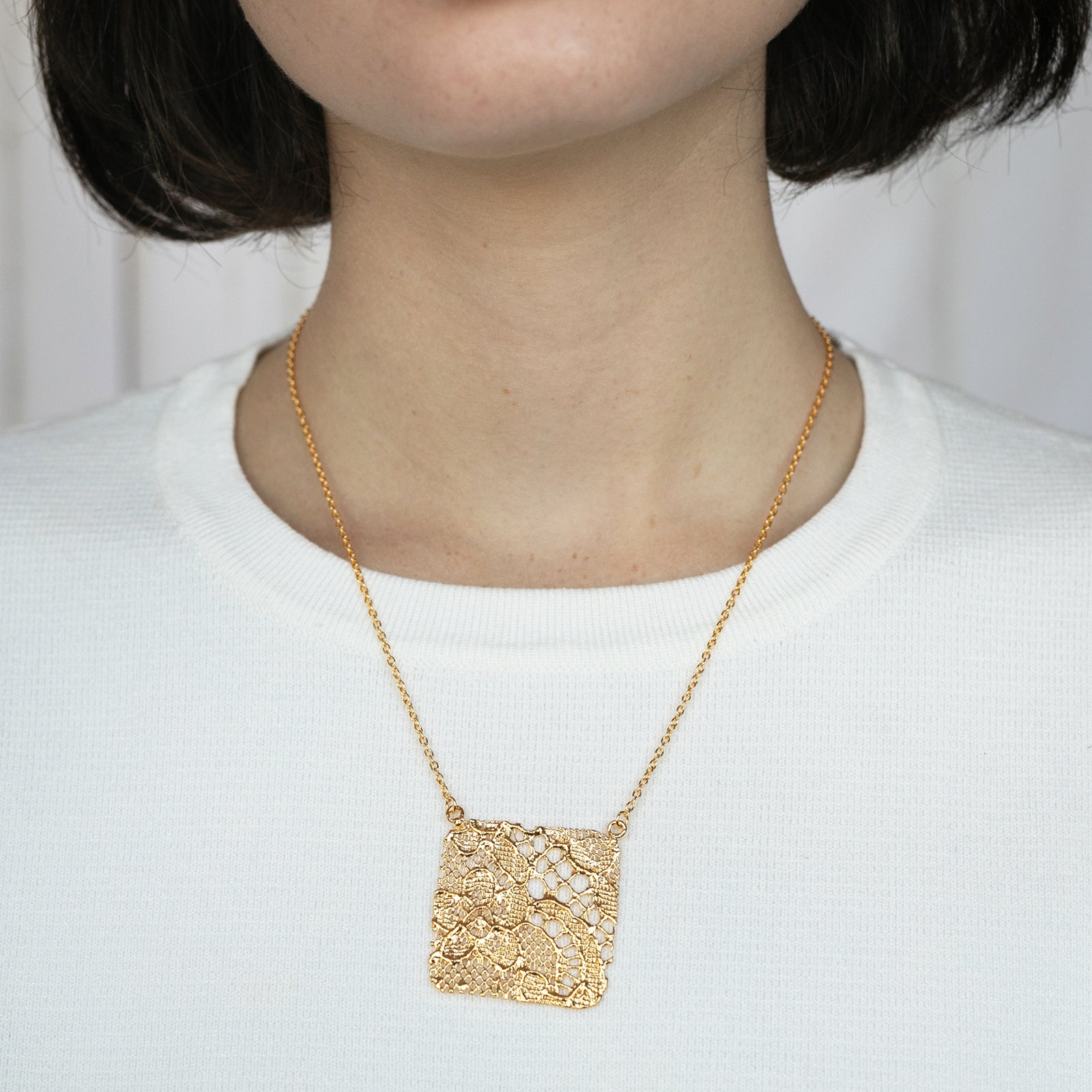 Intricate square pendant lace necklace in 24k gold.
