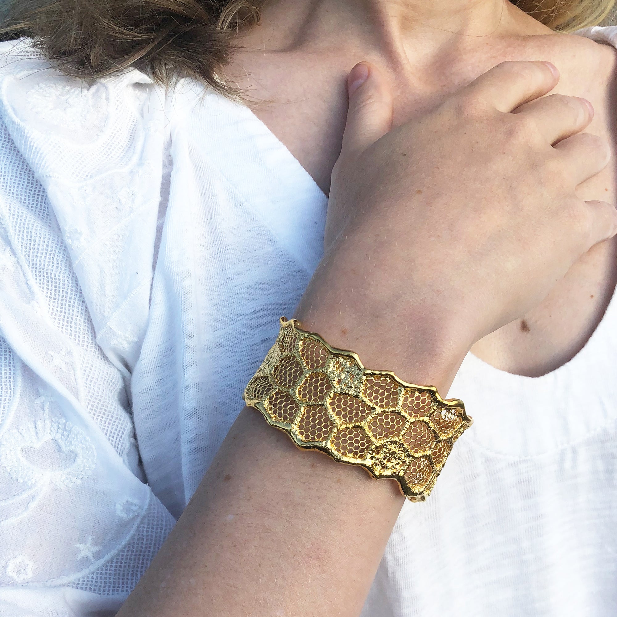 Cuff bracelet made from an intricate honeycomb lace dipped in 24k gold.