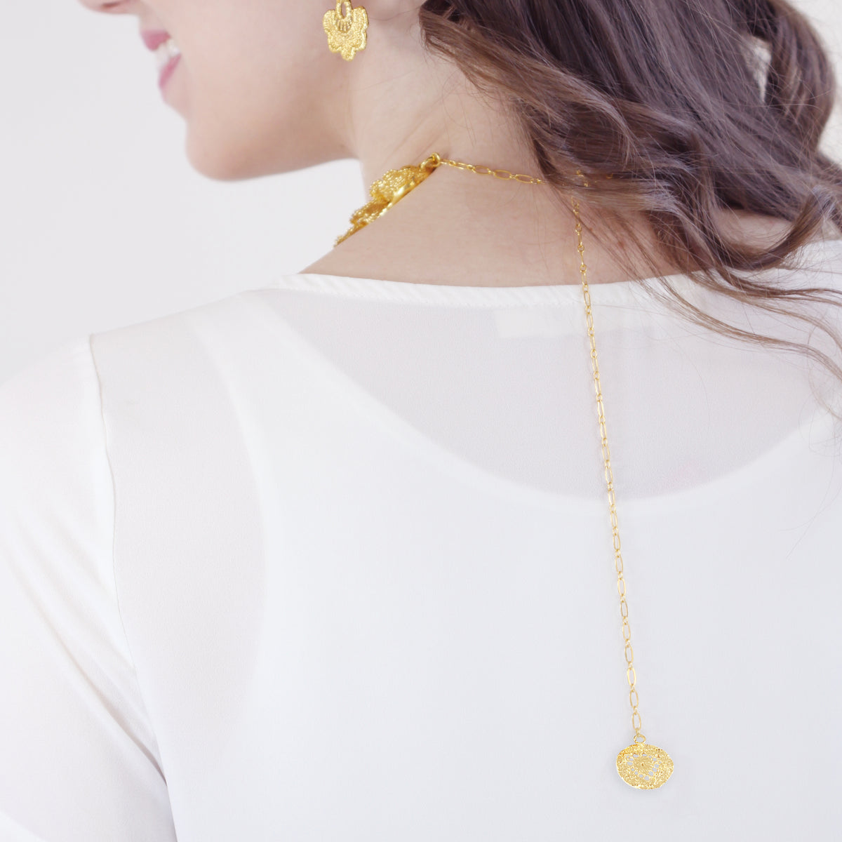 The back of lace choker in 24k gold on model.
