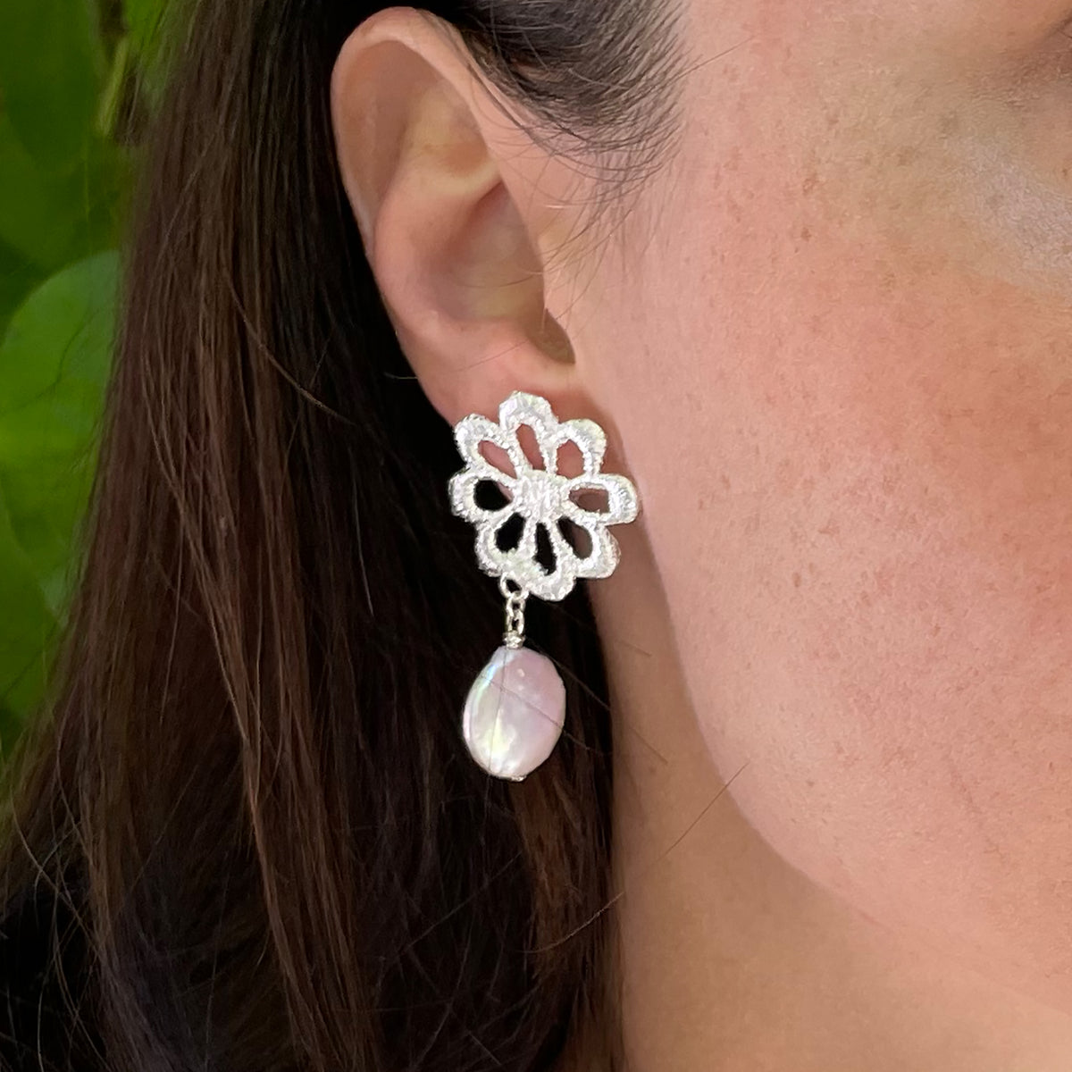 Model wearing baroque coin pearl earring with flower lace in sterling silver.