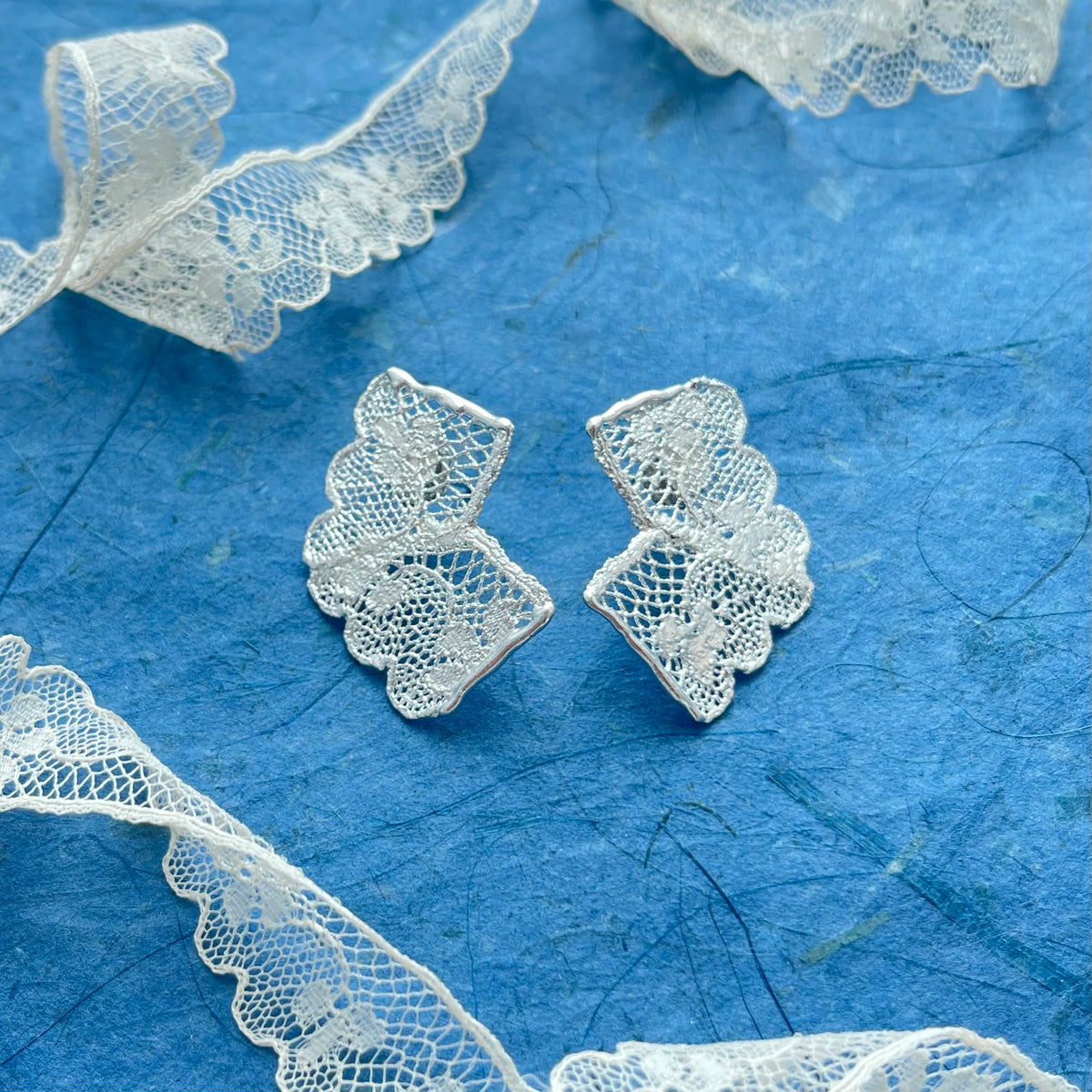 Audra lace stud earrings in sterling silver with the original lace.