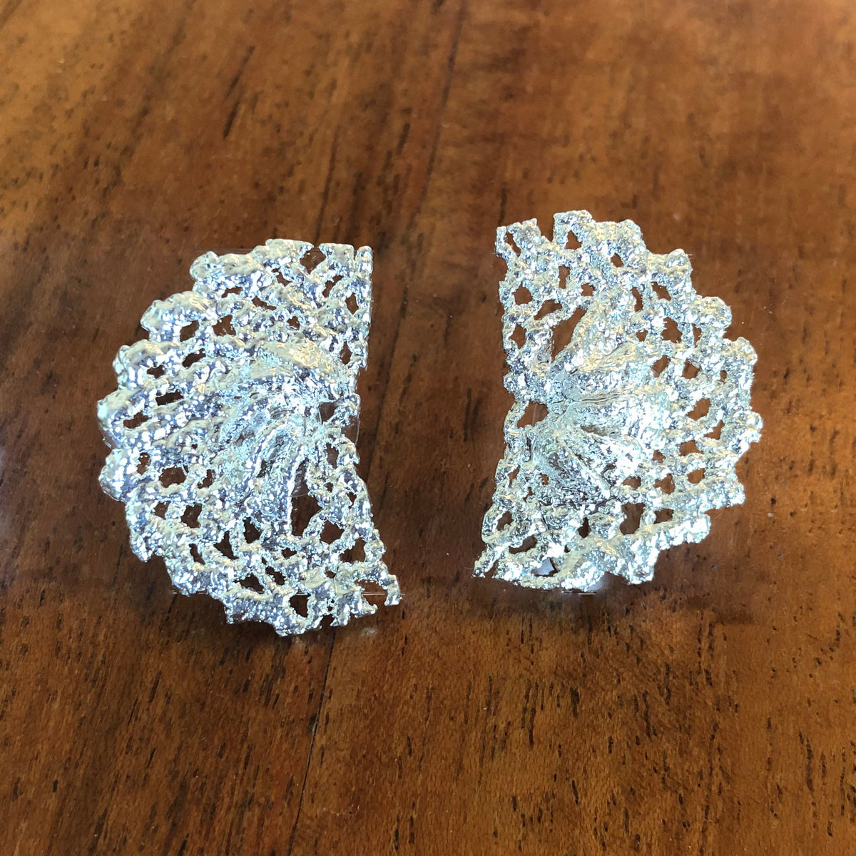Half moon stud earrings made from Swedish lace dipped in sterling silver.