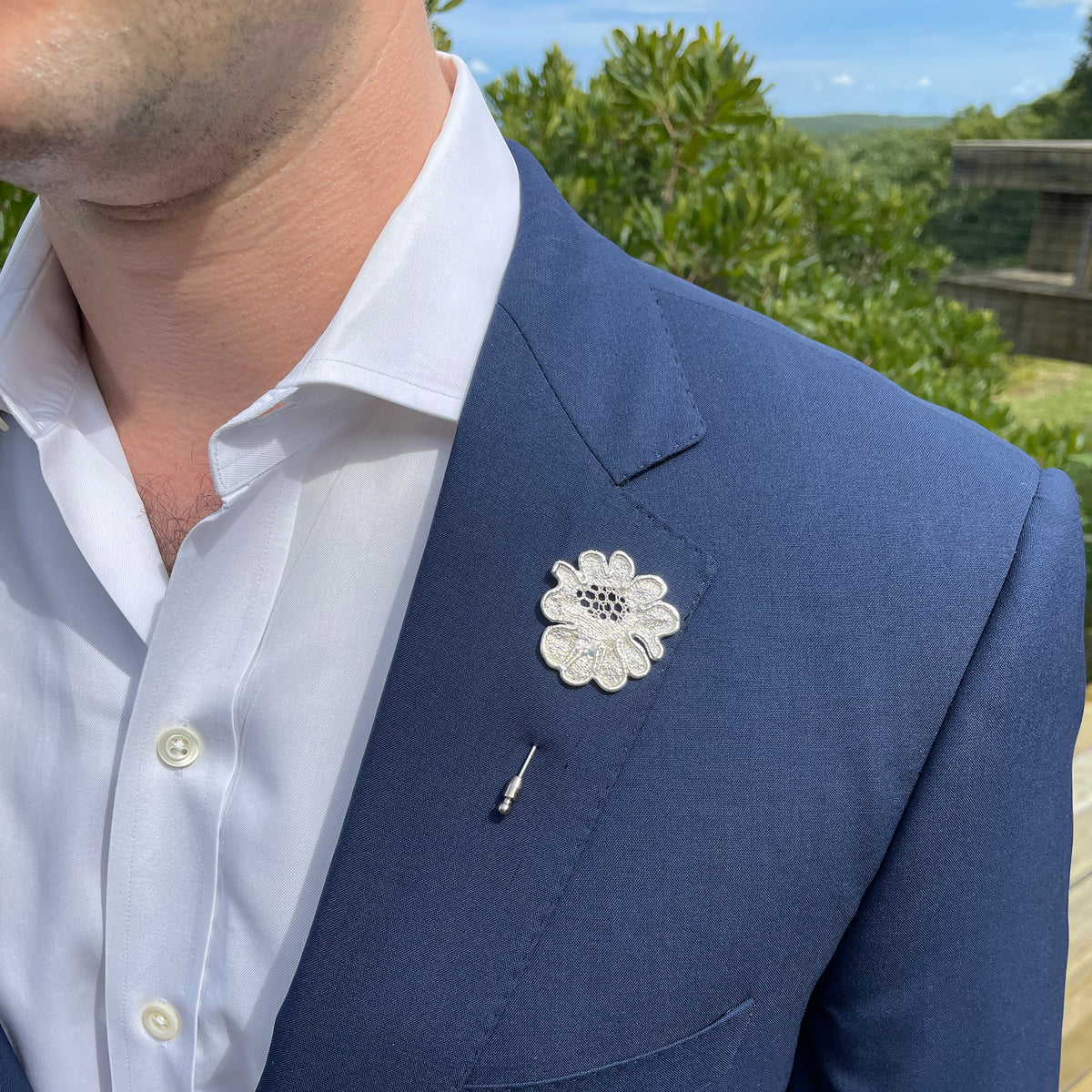 Model wearing Lapel Pin in the shape of a rose made from wedding dress lace dipped in sterling silver.