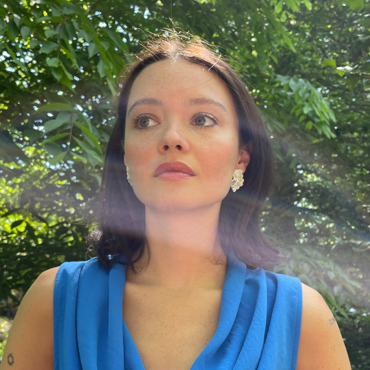 Audra lace stud earrings in sterling silver on model.