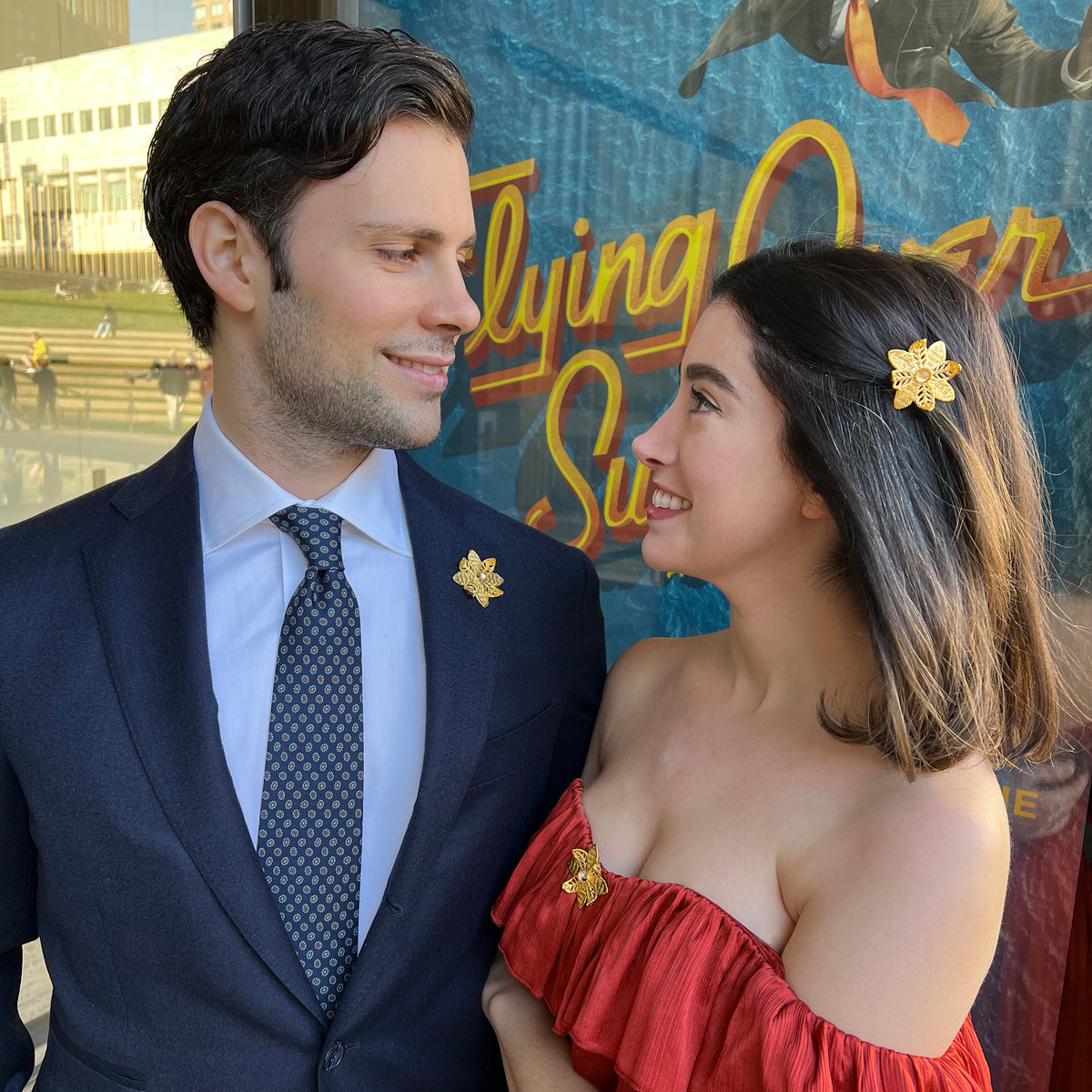 Models wearing Lapel pin and brooch 24k gold lace flower with 10mm white Topaz.