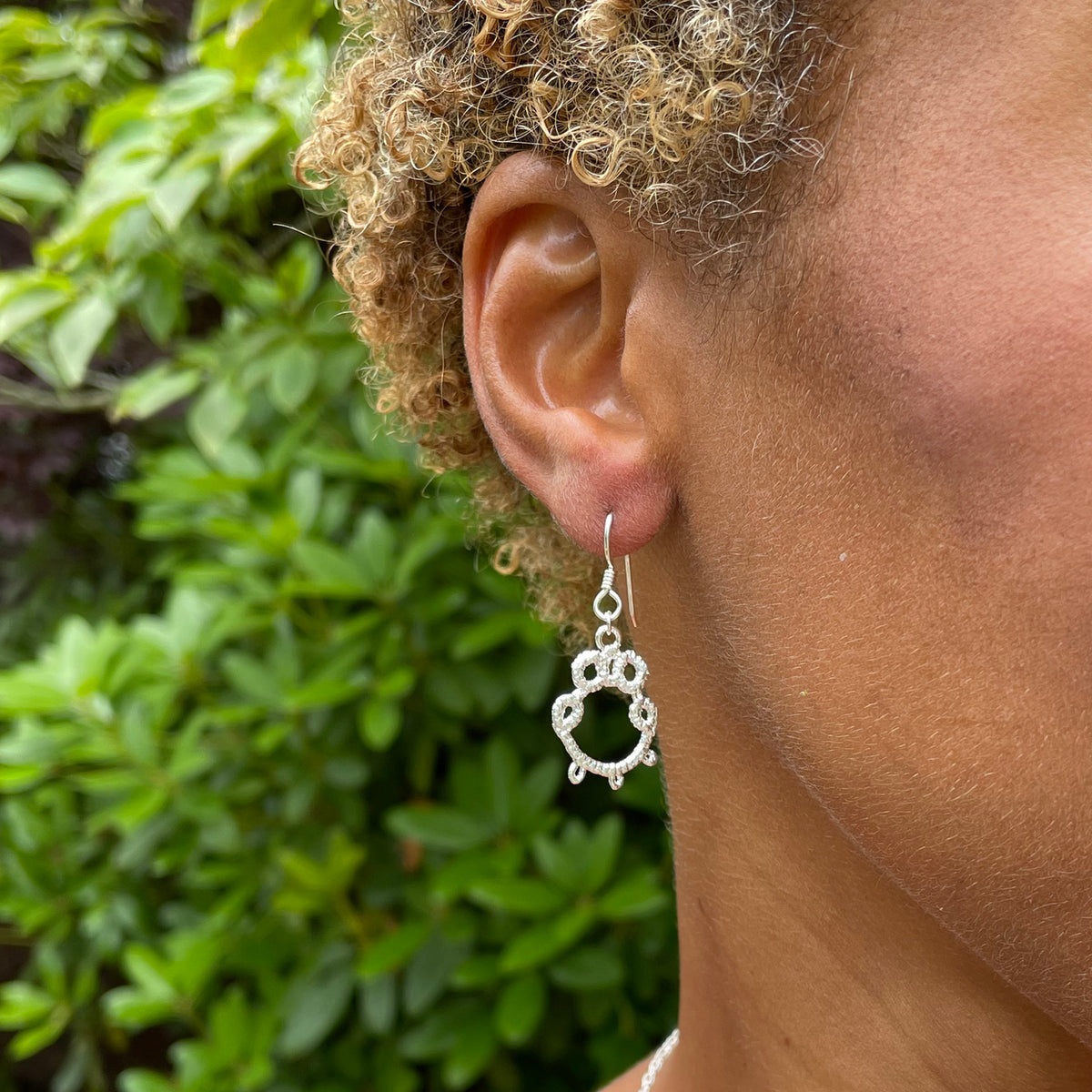 Irish tatted lace earrings in sterling silver worn by model.