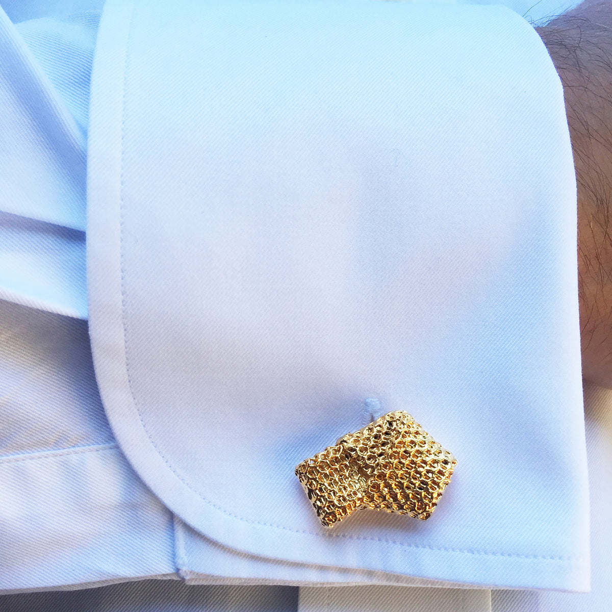 Model with Cufflinks made from wedding dress tulle tied in a knot and dipped in 24k gold.