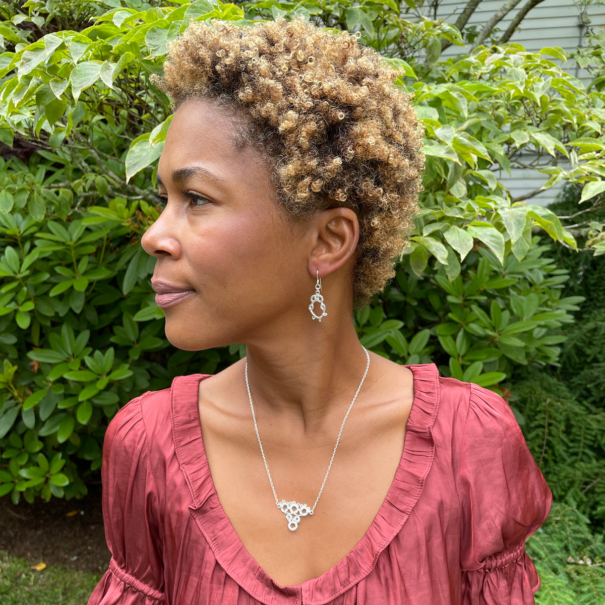 Irish tatted lace earrings in sterling silver worn by model.