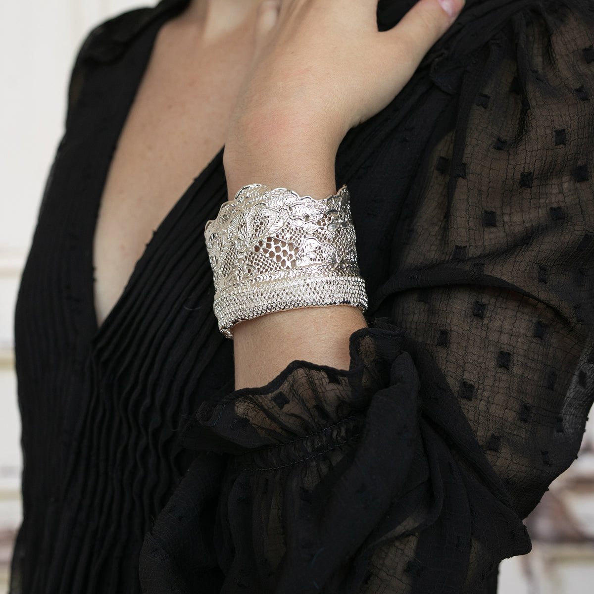 Model showing Silver lace cuff bracelet, mix of feminine Chantilly lace and masculine mesh. Dipped in sterling silver.