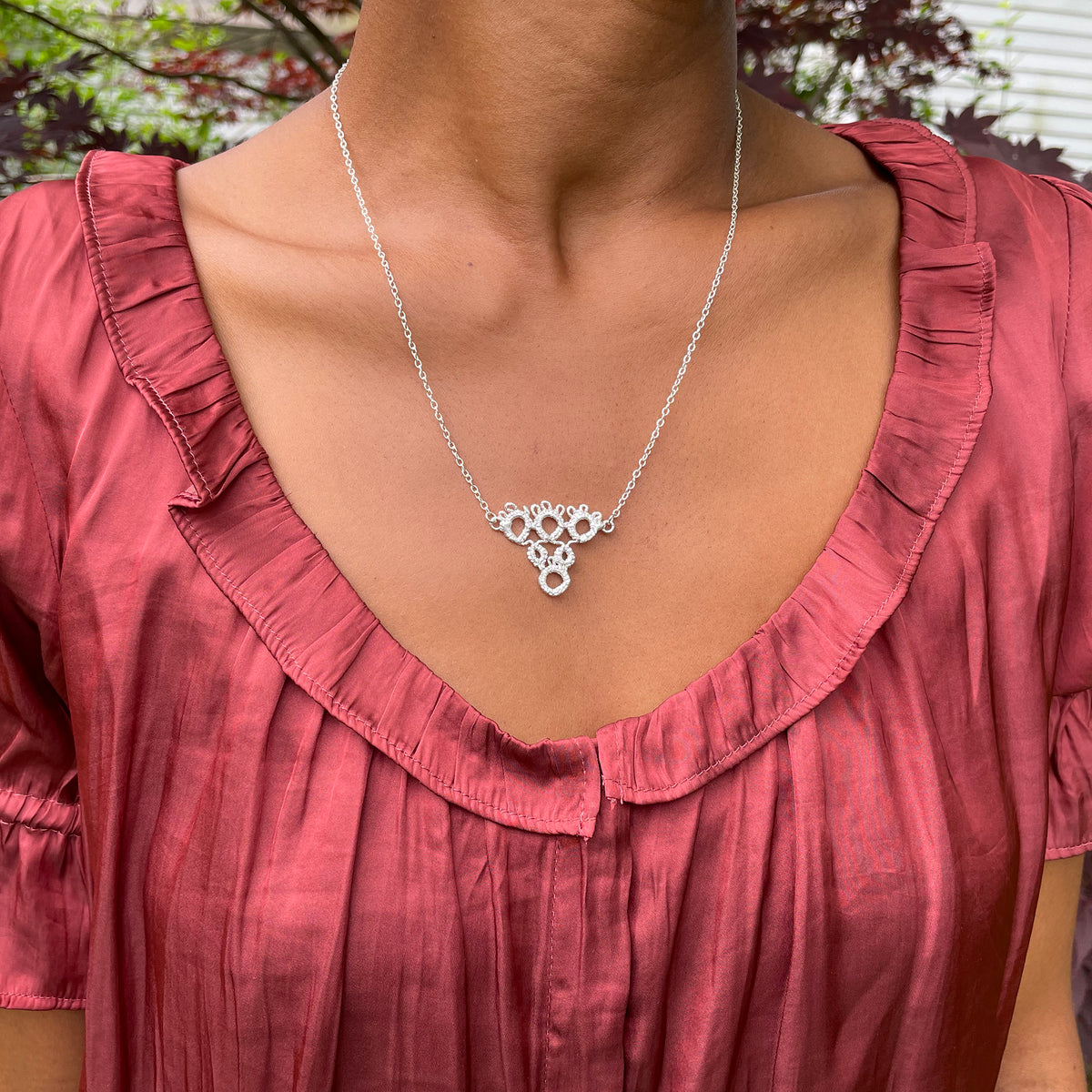 Irish tatted lace pendant necklace in sterling silver on model.
