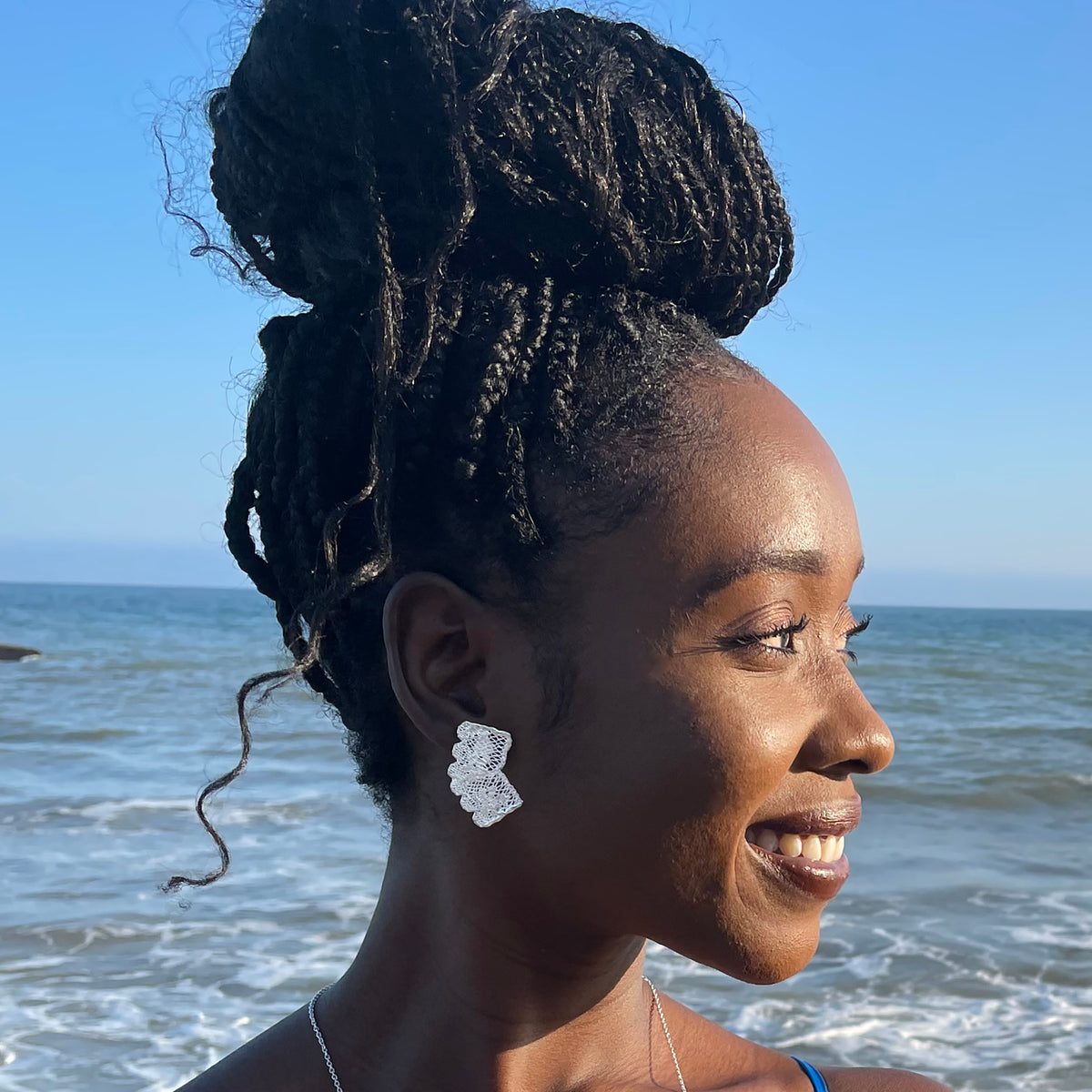 Audra lace stud earrings in sterling silver on model.