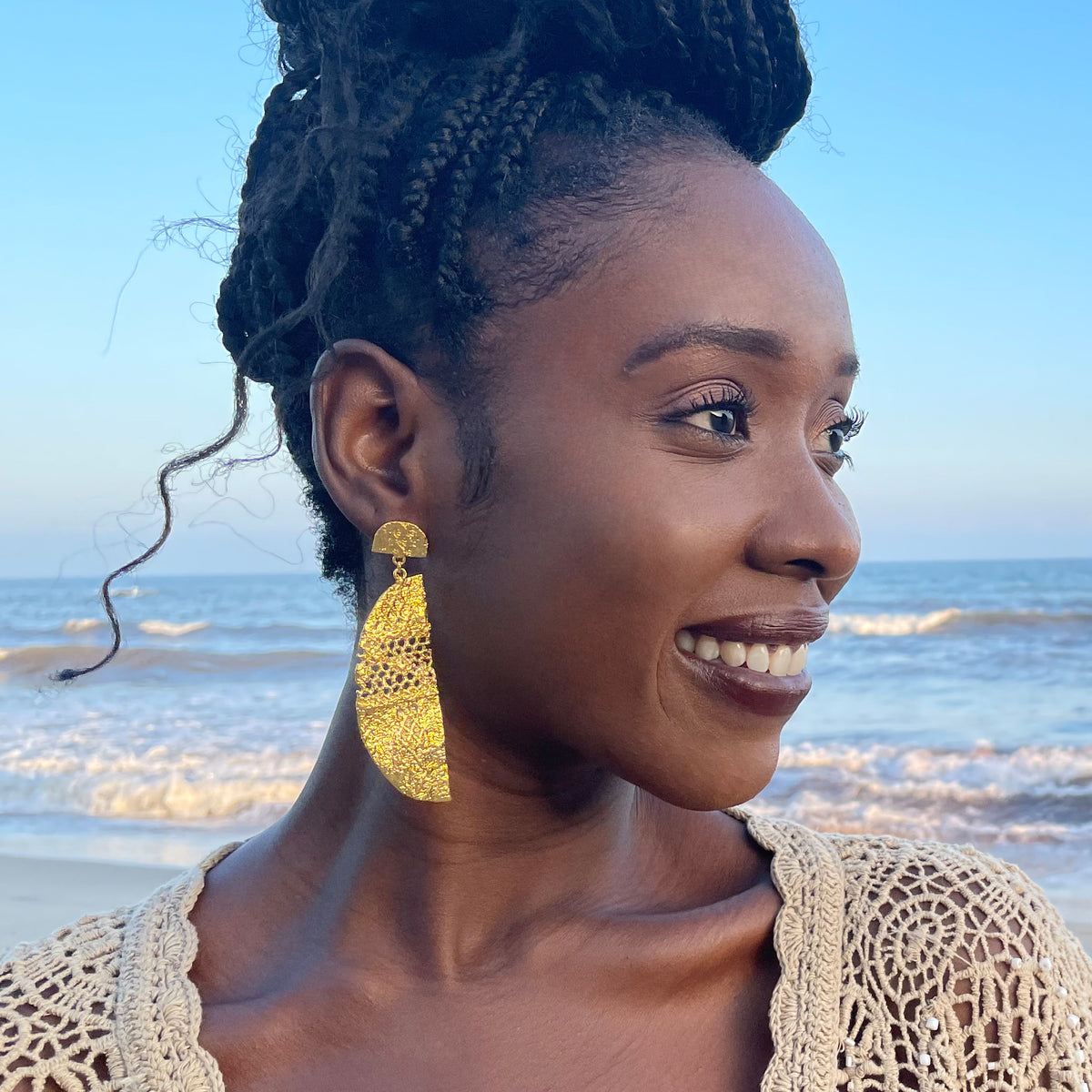 Model wearing half moon lace earrings in 24k gold.
