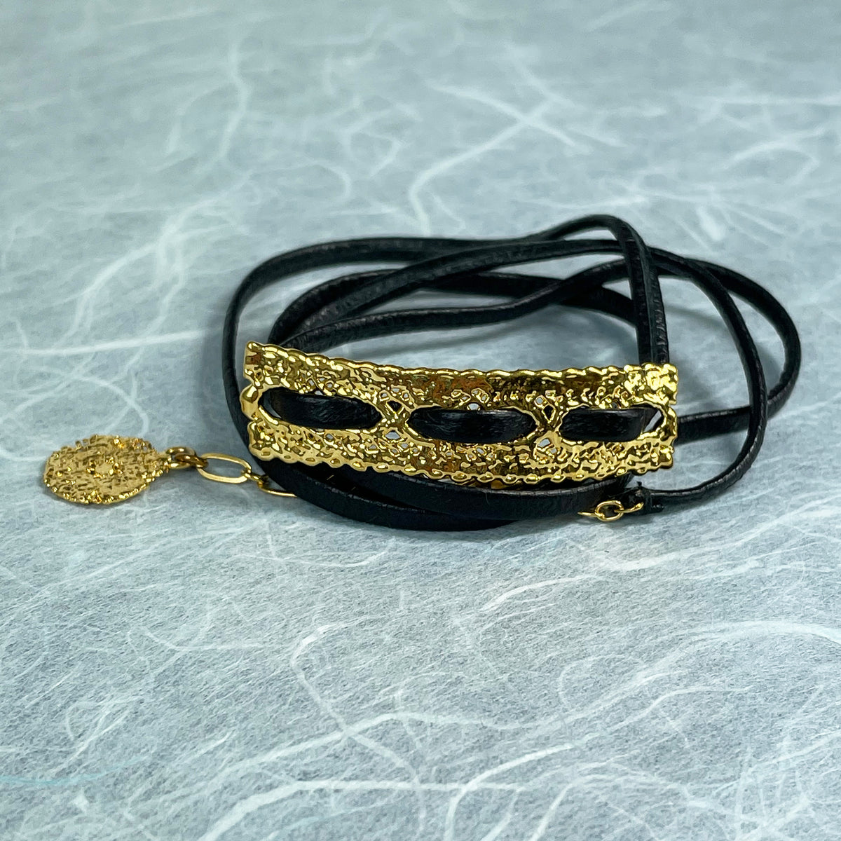 Leather bracelet with vintage lace dipped in 24k gold.