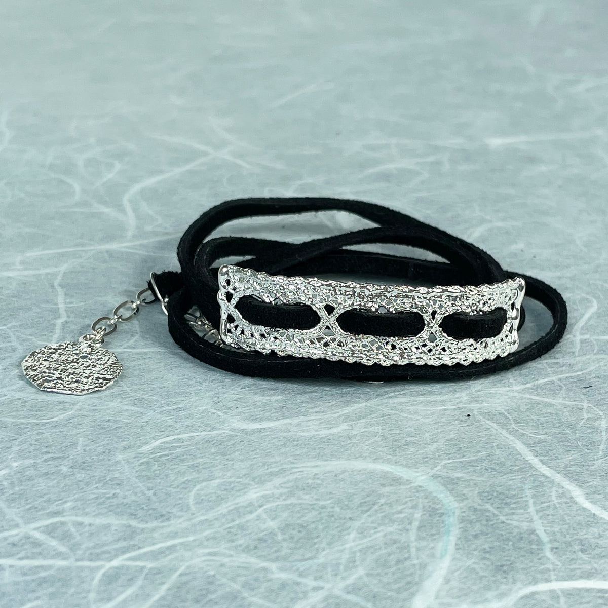 Leather bracelet with vintage lace dipped in sterling silver.