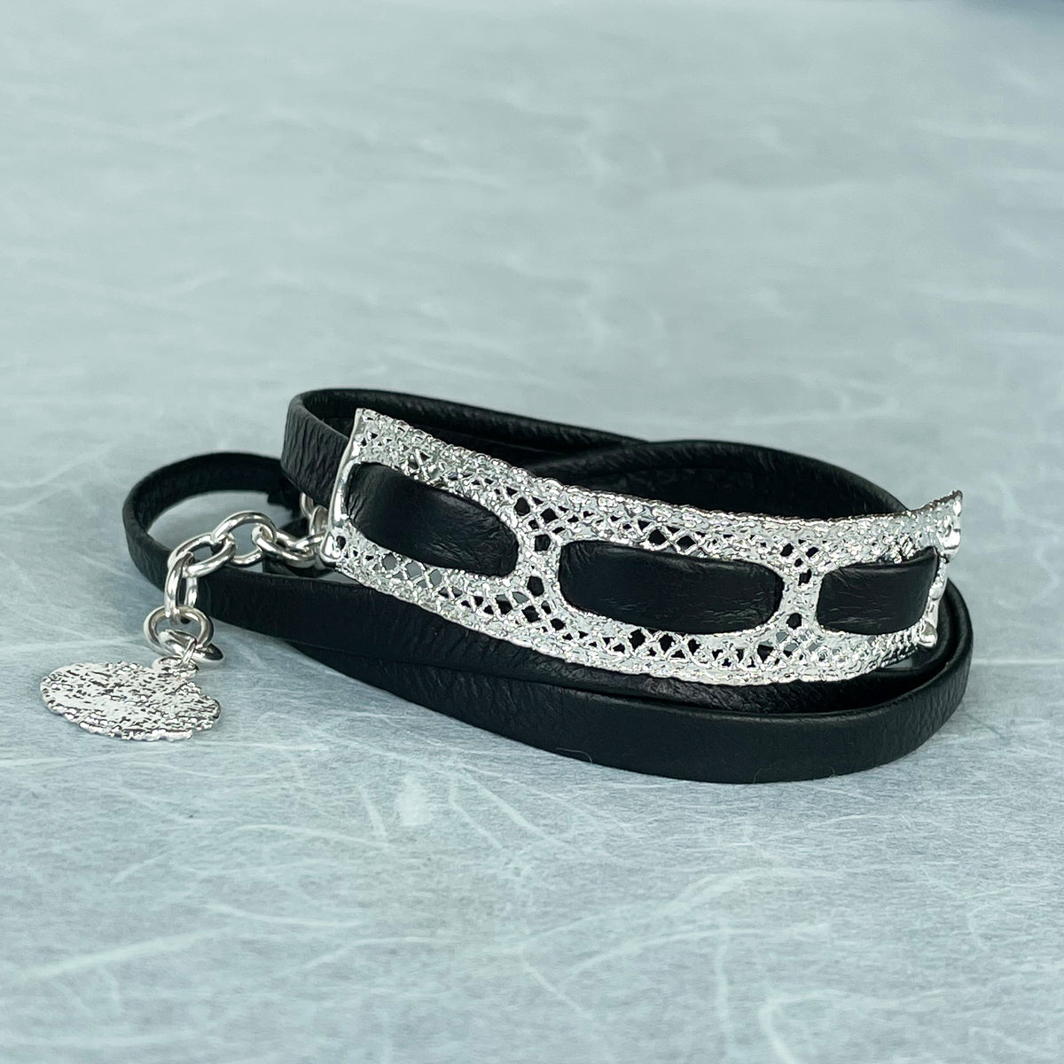 Leather bracelet with vintage lace dipped in sterling silver.