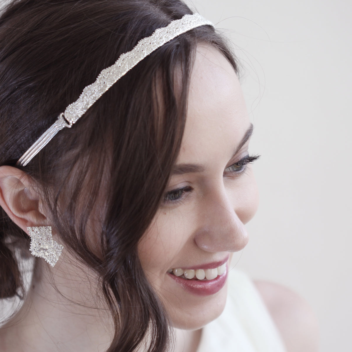 Model showing tiara made from 1920s lace solidified in sterling silver with silk ribbons.