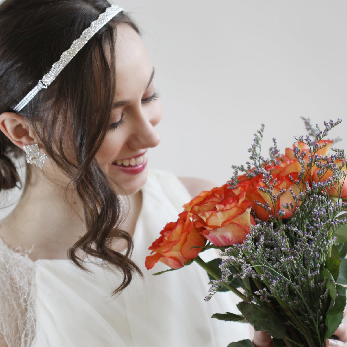 Model showing tiara made from 1920s lace solidified in sterling silver with silk ribbons.