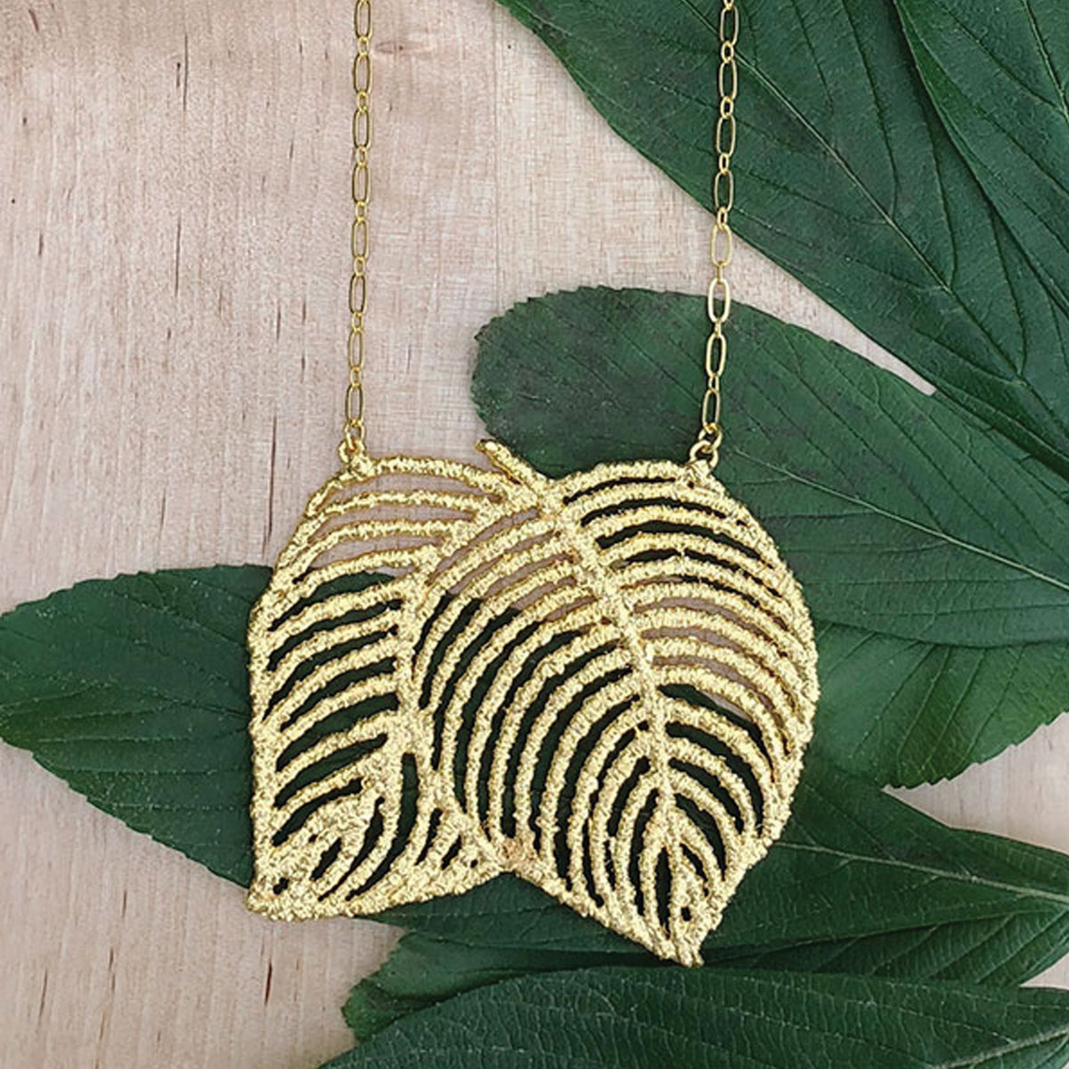 Lace Leaf necklace in dipped 24k gold.