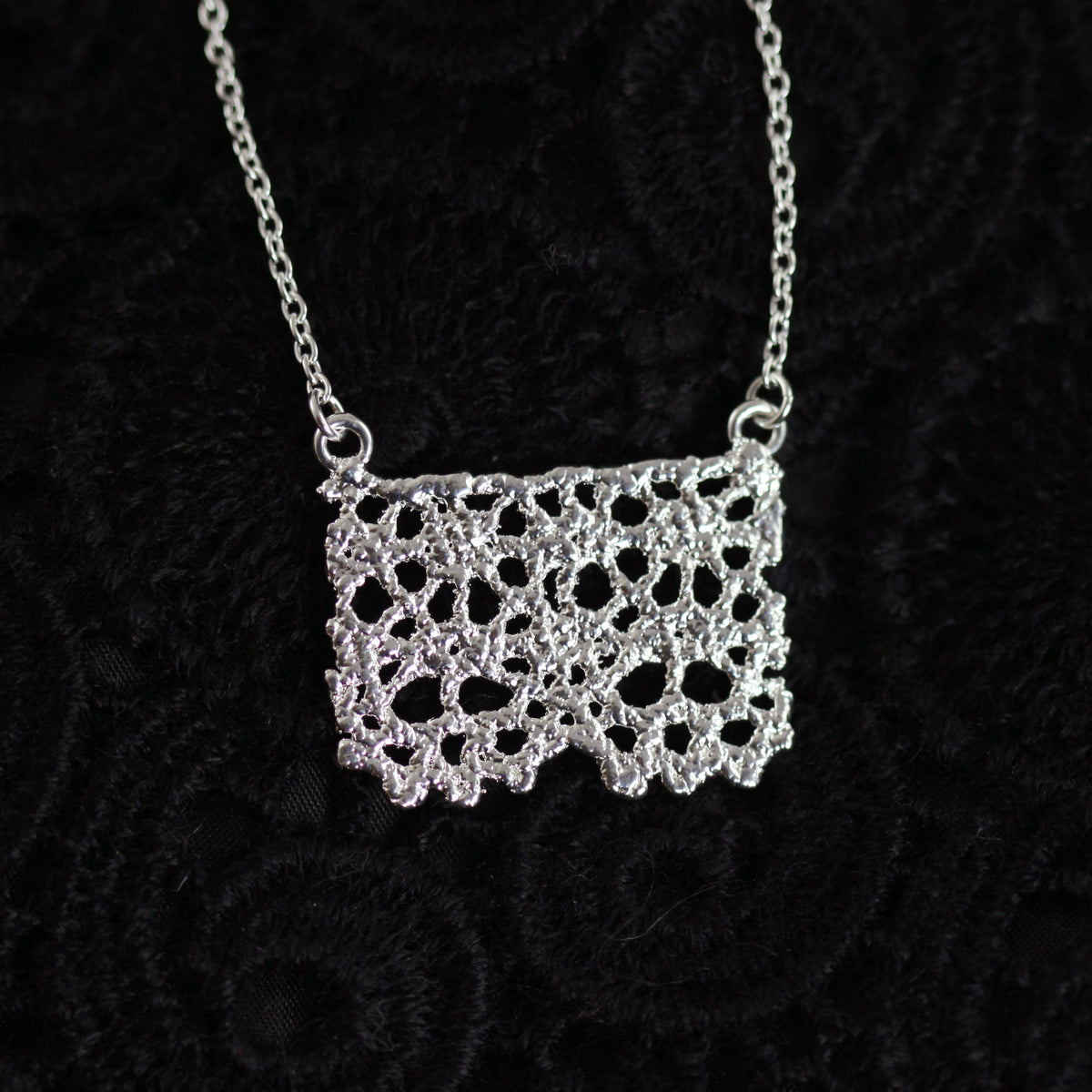 Swedish lace pendant necklace dipped in sterling silver.