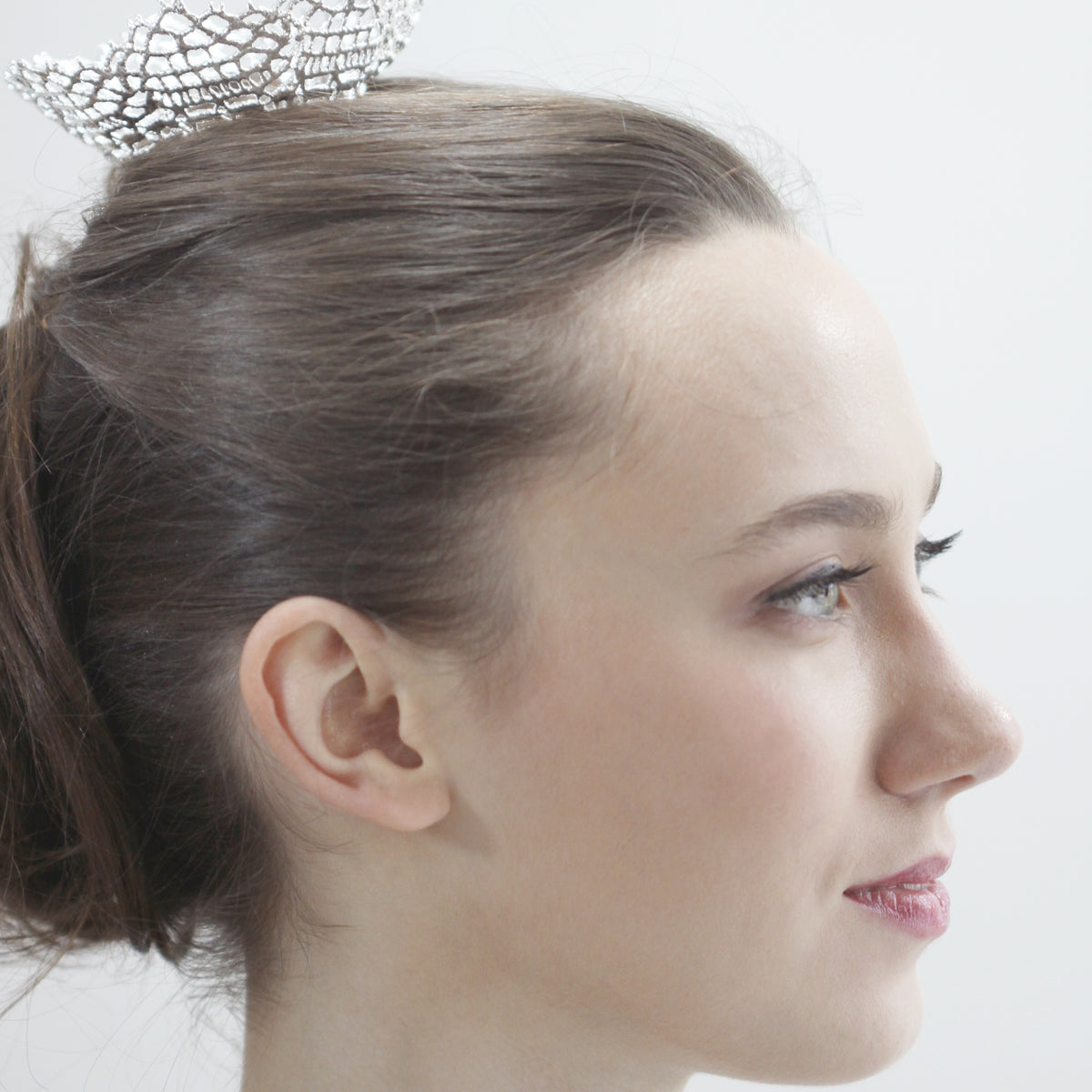Lace crown head piece in sterling silver worn by a model.