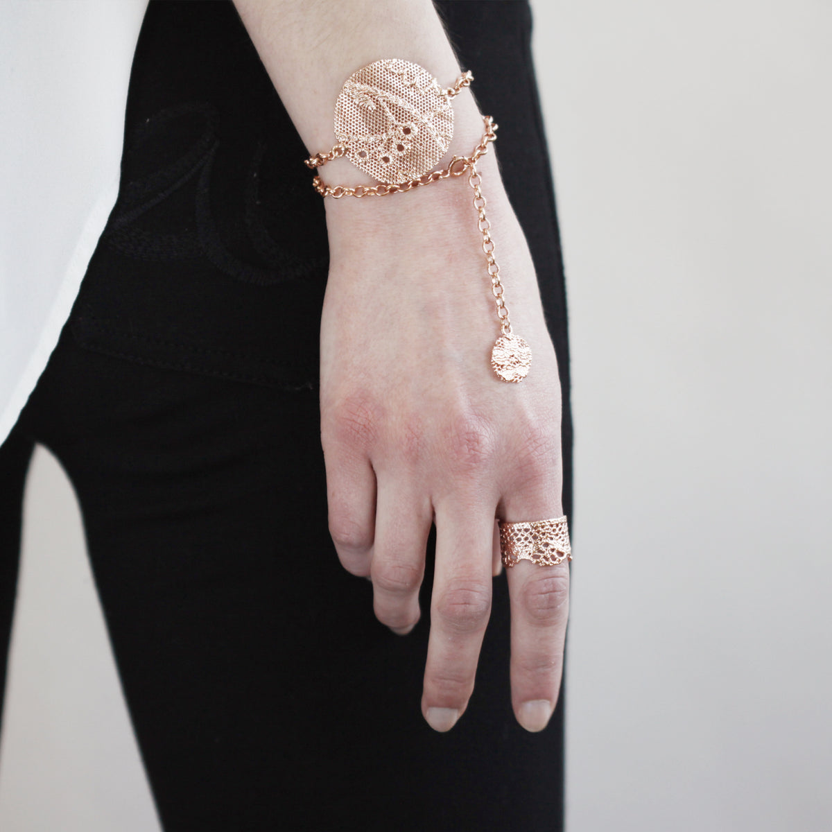 Charlie lace chain bracelet in rose gold with intricate details.