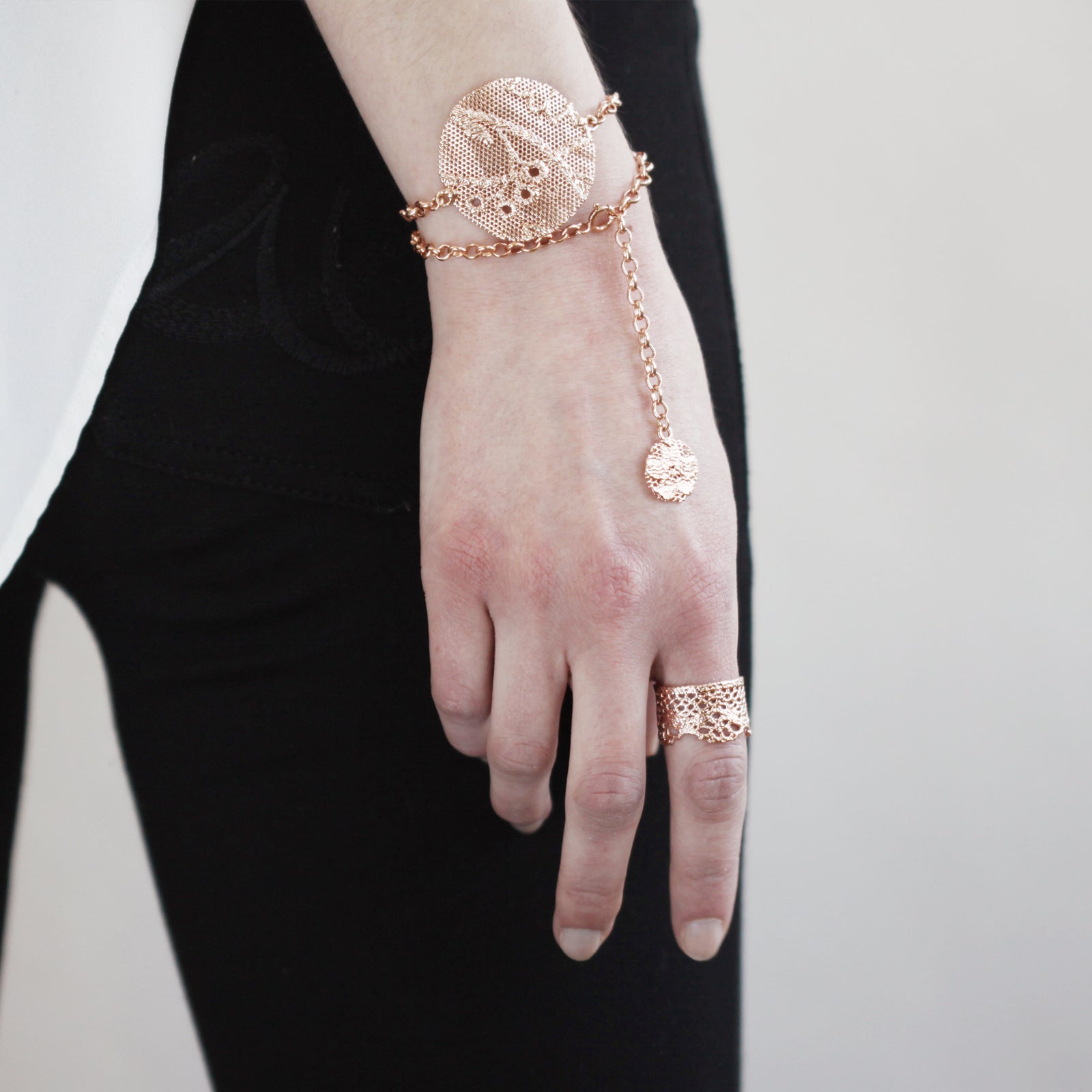 Charlie lace chain bracelet in rose gold with intricate details.