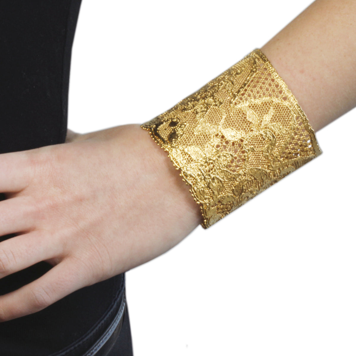 The Dorothy lace cuff in 24k gold made with 1940s American lace worn by a model.